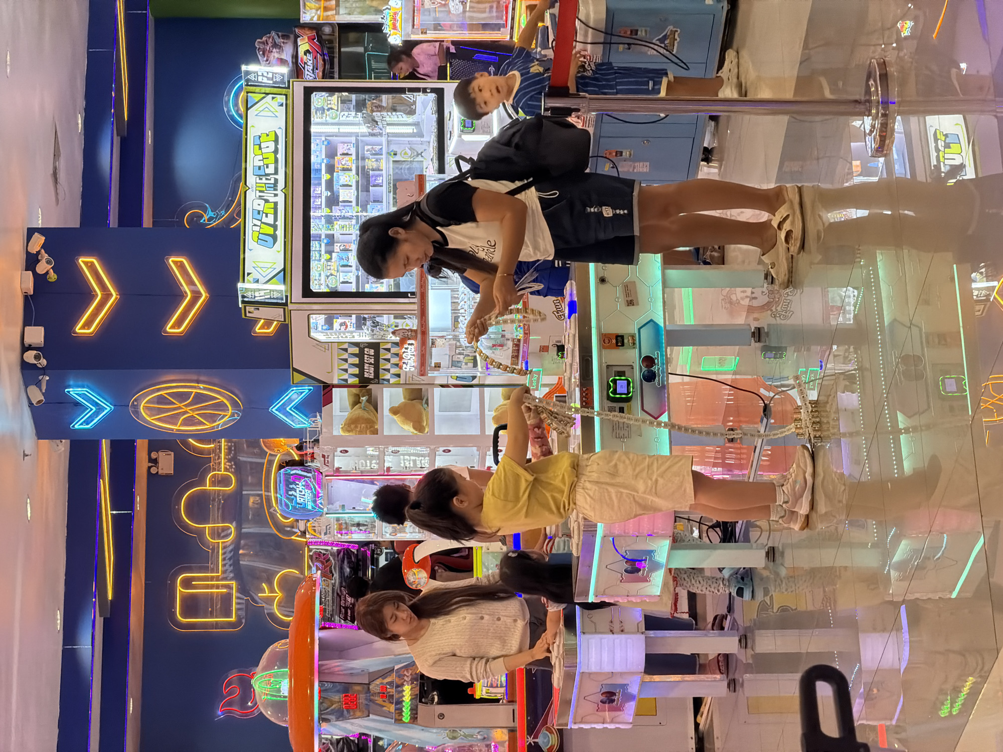 Family group enjoys arcade games in Chiang Mai