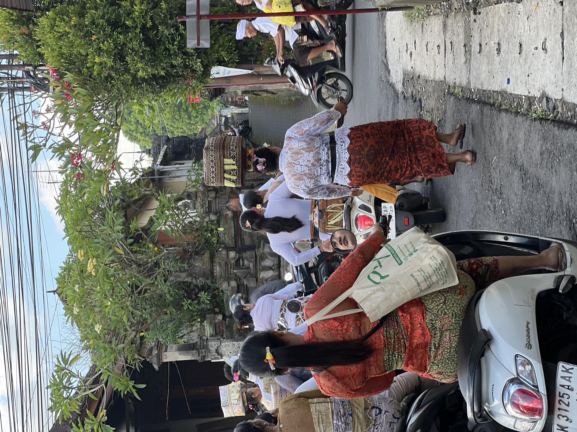 Balinese Hindus carry offerings to temple ceremony in Singakerta