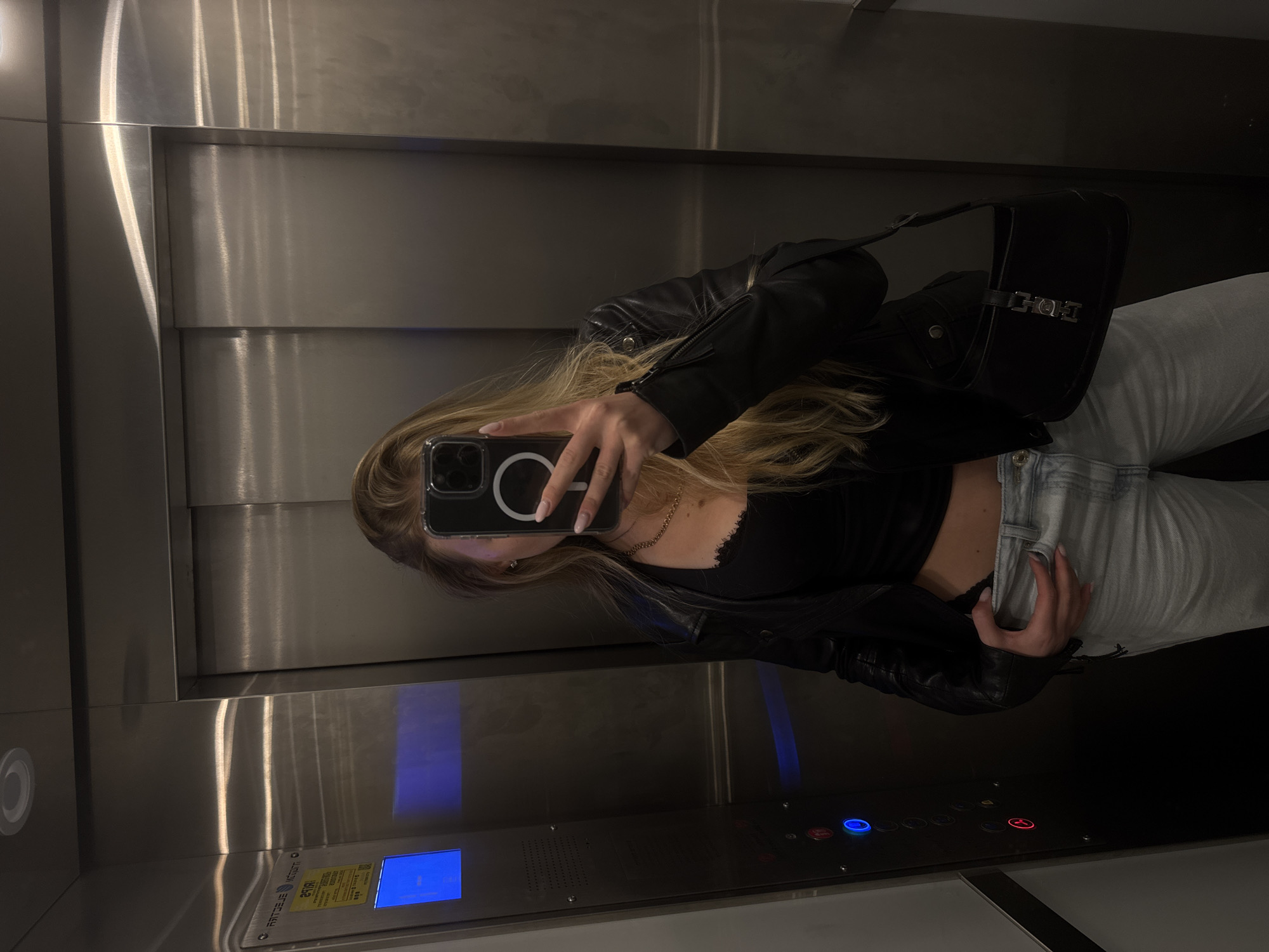 Woman in black jacket observed in elevator, car in Tel Aviv
