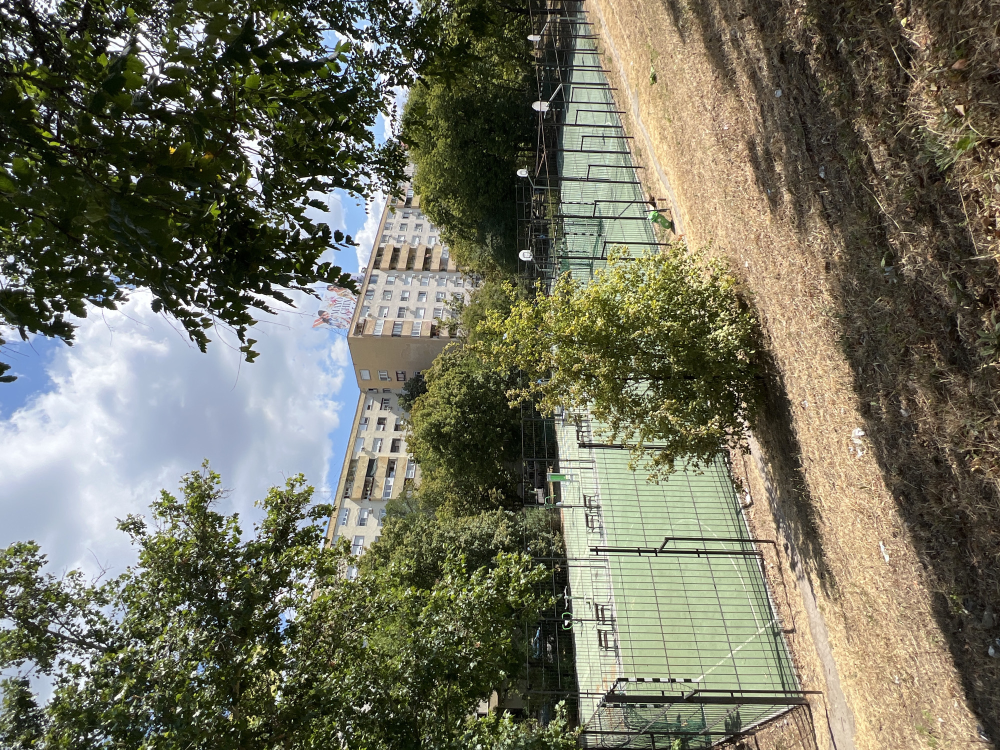 Budapest street-level mix: sports court meets modern office block