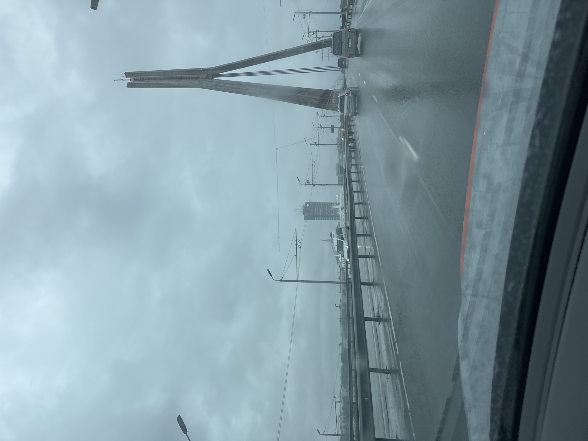Crossing a rain-soaked cable-stayed bridge in Riga