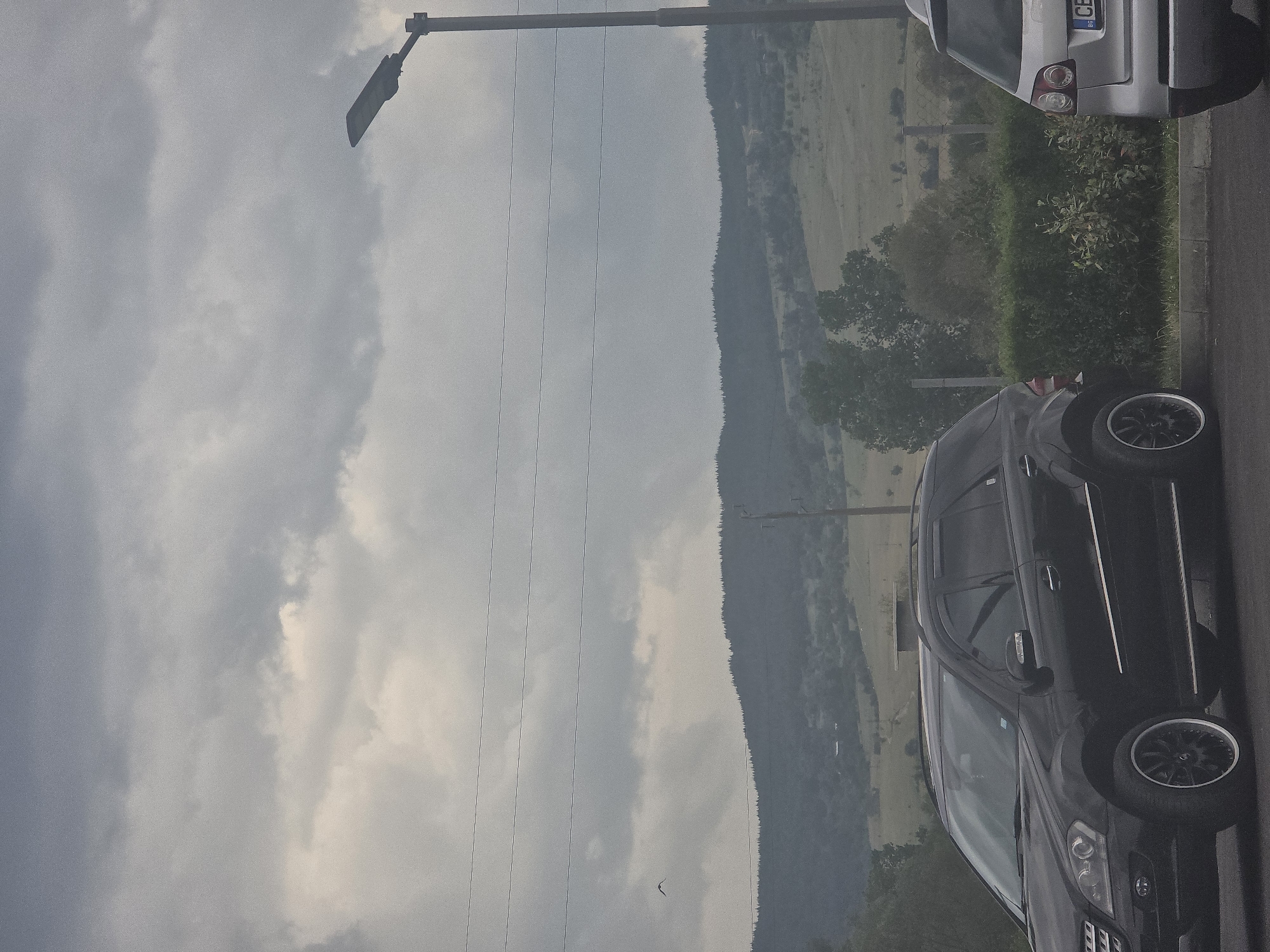 Overcast morning captured with parked cars, mountains in Kraishte