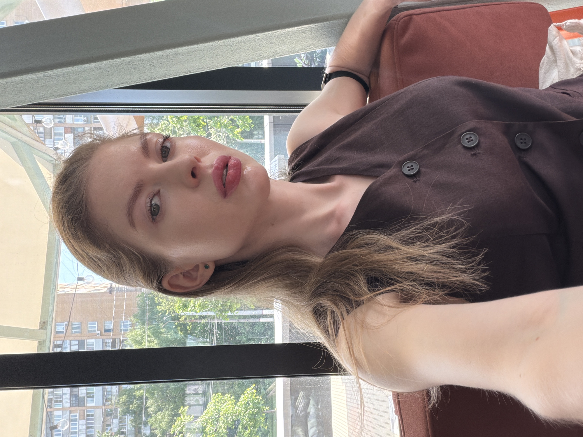 Woman takes indoor selfie in Khimki with cityscape backdrop