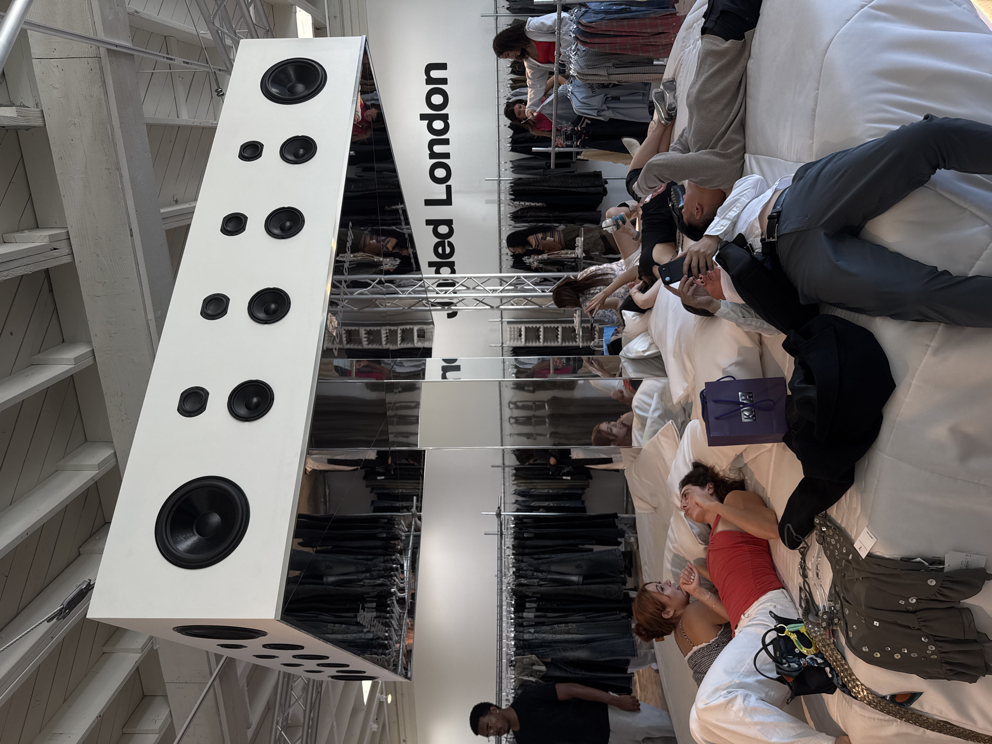 People rest on white surfaces in West Hollywood retail space