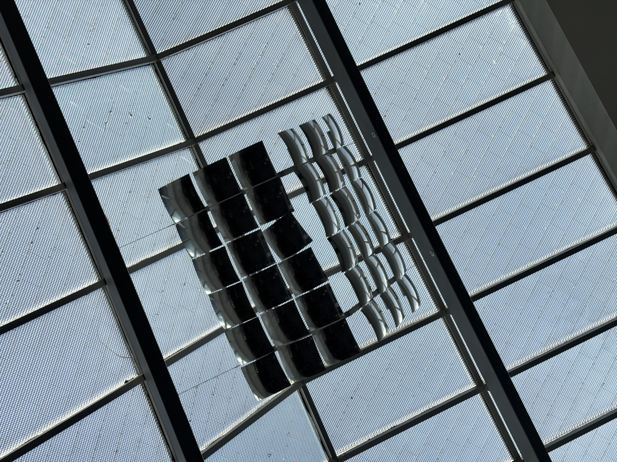 Travelers document Zurich Airport's distinctive geometric ceiling architecture