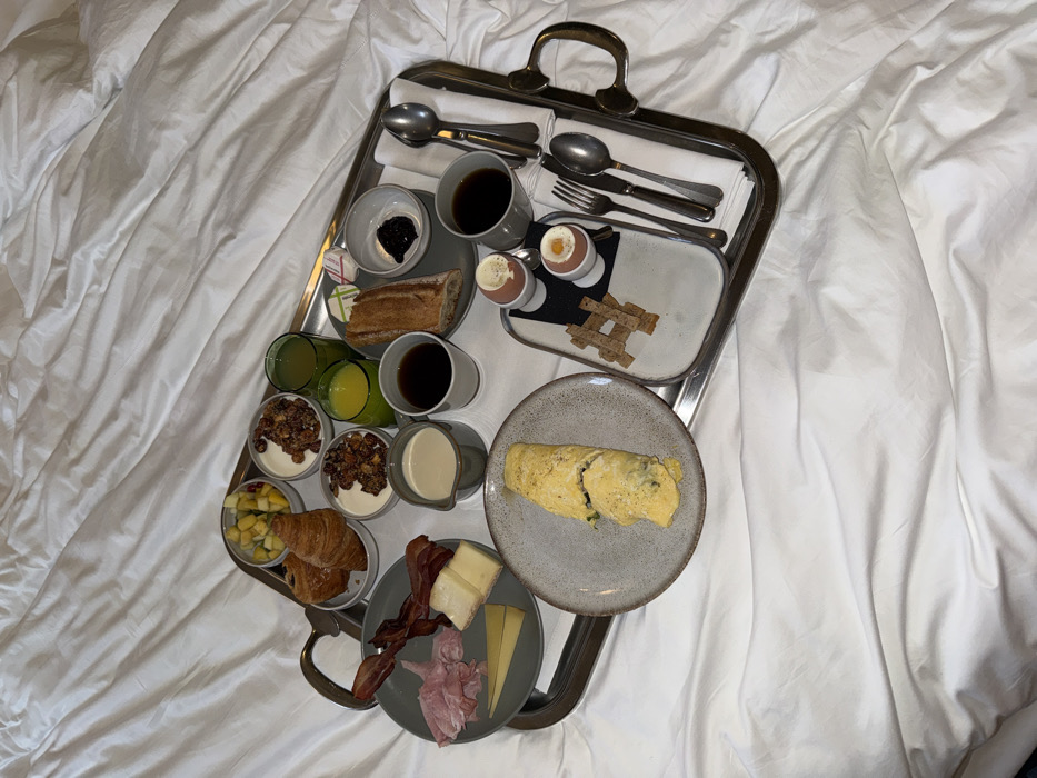 Breakfast tray documented on bed in Paris morning