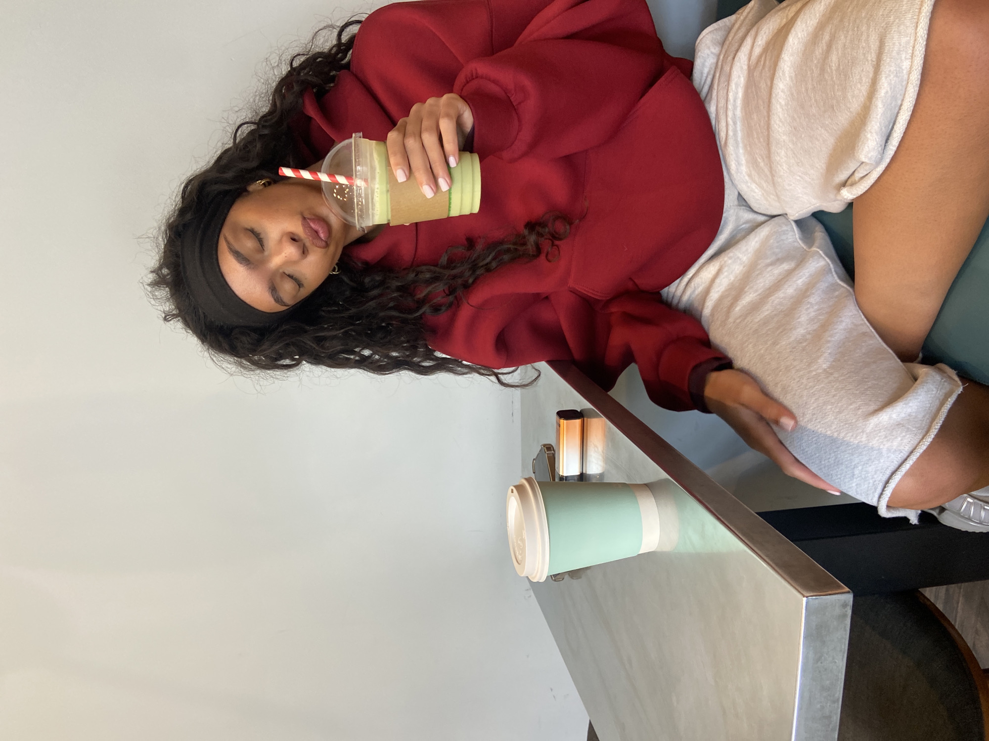 Woman enjoys green smoothie at London table