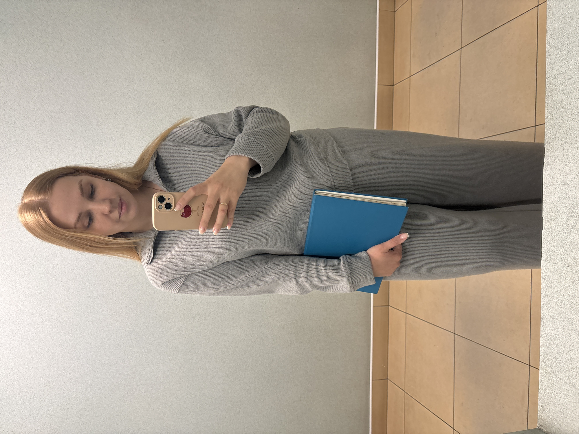 Woman takes selfies with blue book in Rusanovo facility