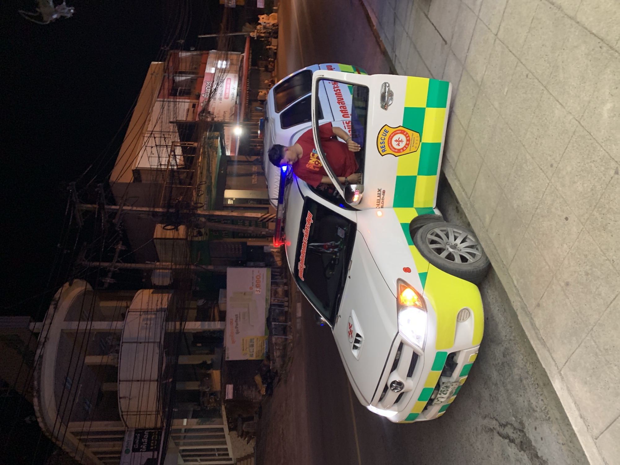 Ambulance parked roadside at night in Baan Bo Phut