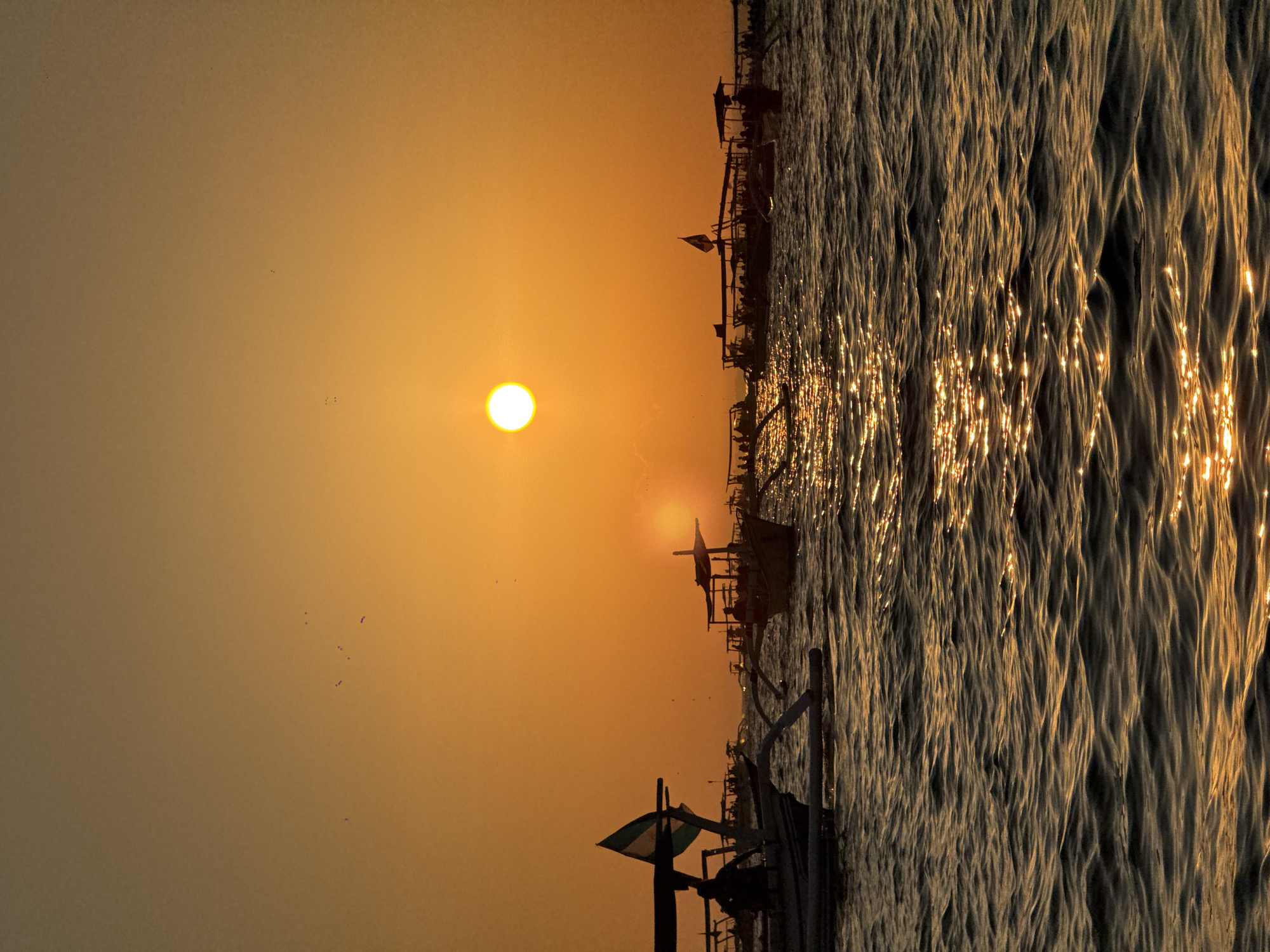 Traditional outrigger boats on the Bali Sea at sunset