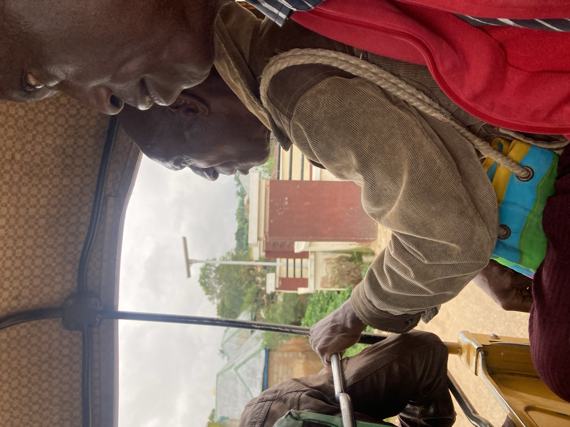 Rickshaw ride through Jos, Nigeria, hillside village in view