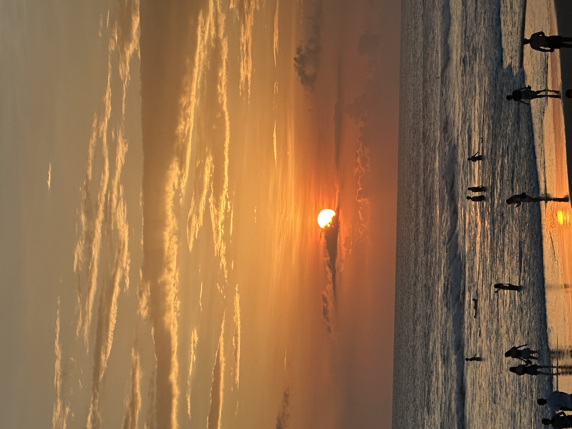 Sunset beach scenes with surfboards captured by witness