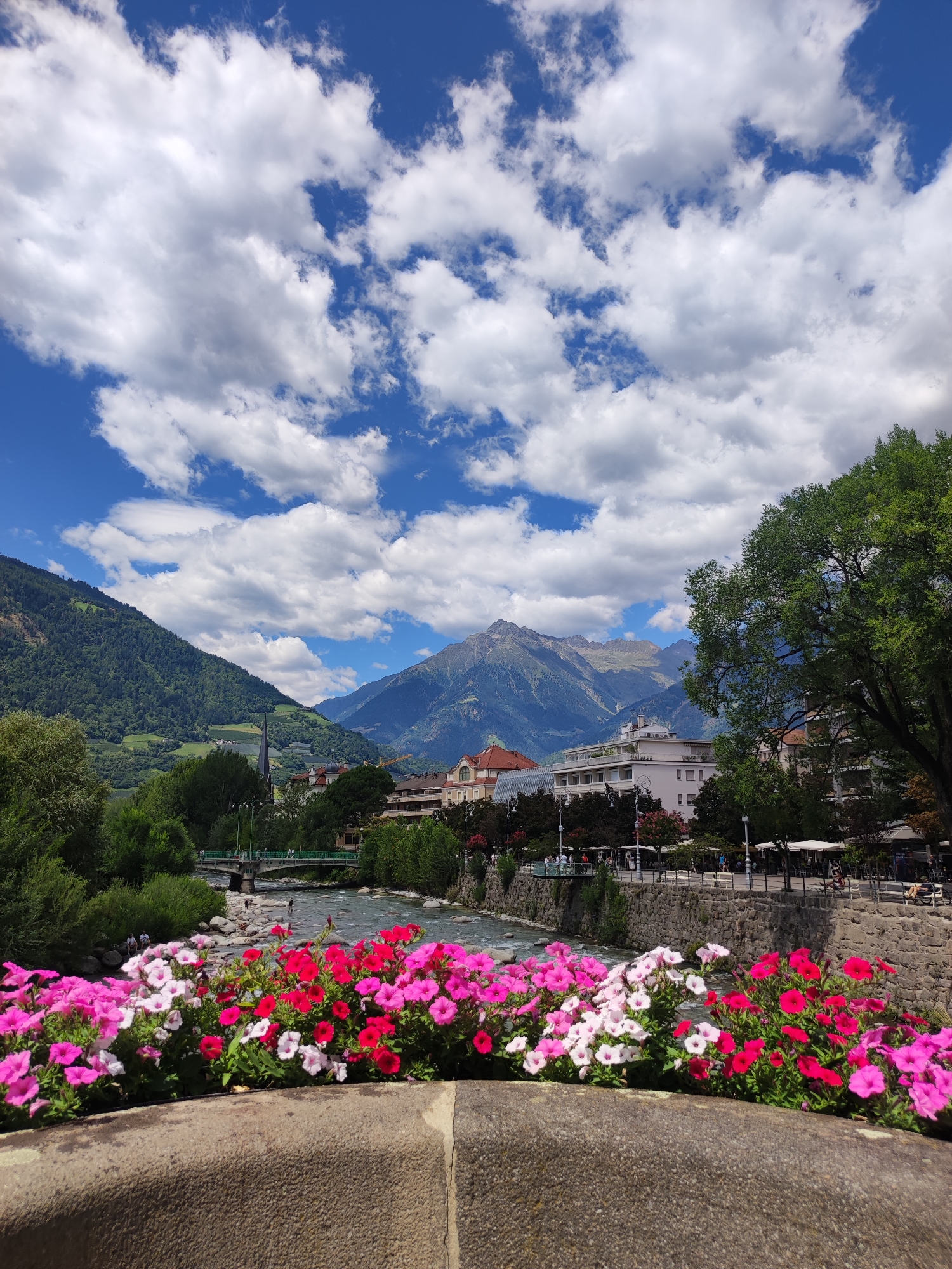 Flowers line the Passer River in Merano, Italy