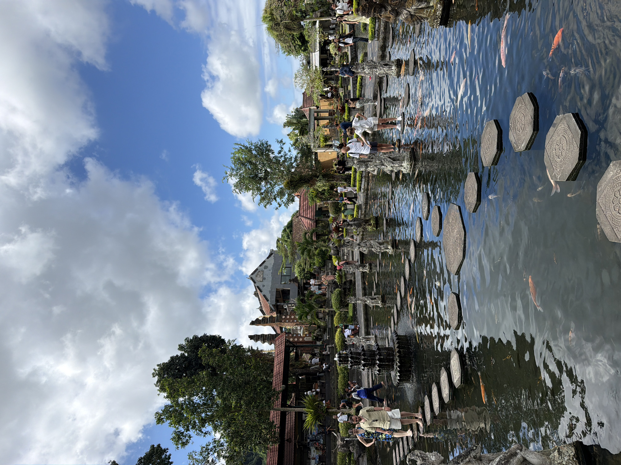 Koi ponds and stone statues at Tirta Gangga Water Palace