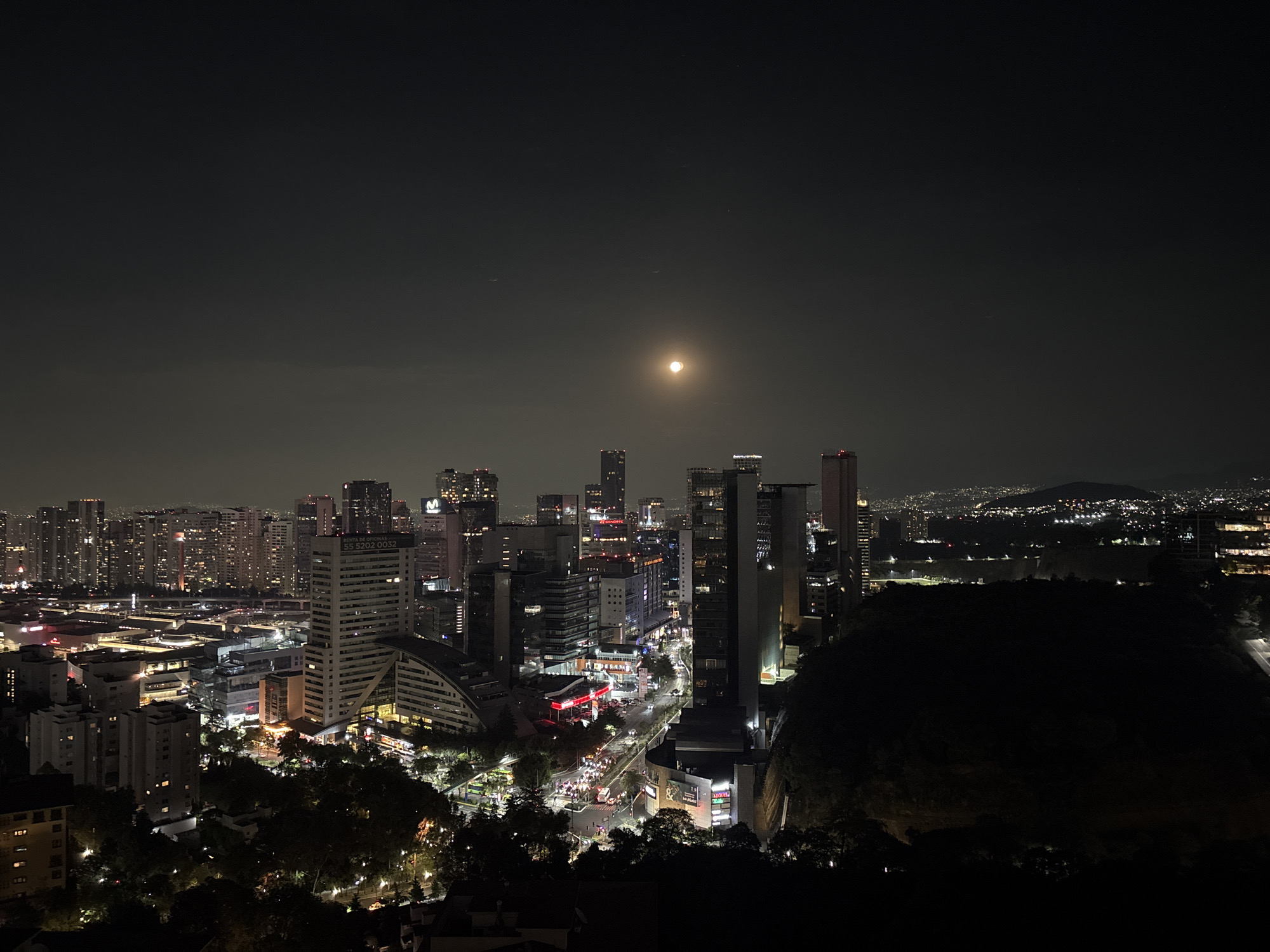 Full moon illuminates Mexico City skyline at night