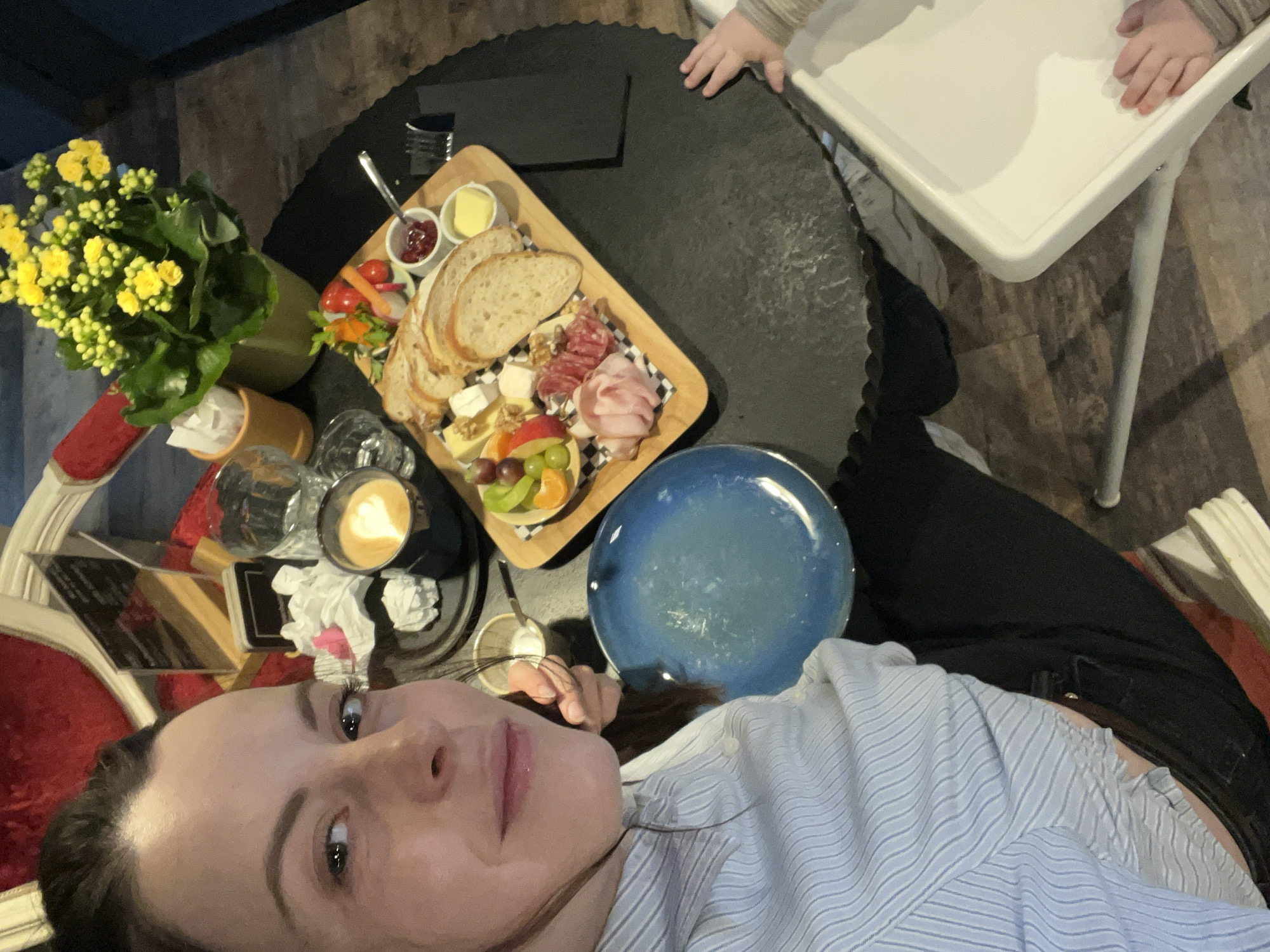 Woman enjoys elaborate breakfast charcuterie board in Meisenheim