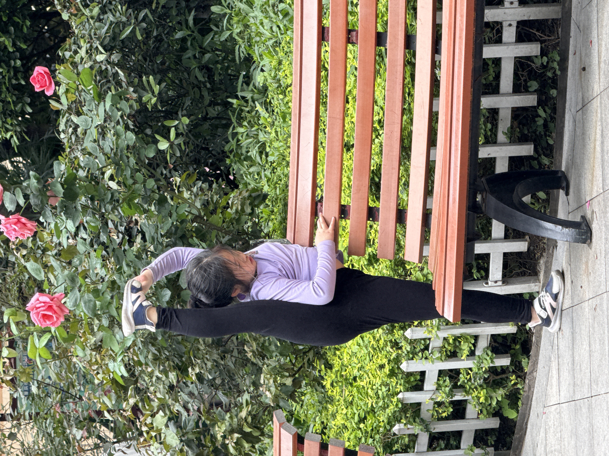 Woman performs morning stretches in Yuzhong District park
