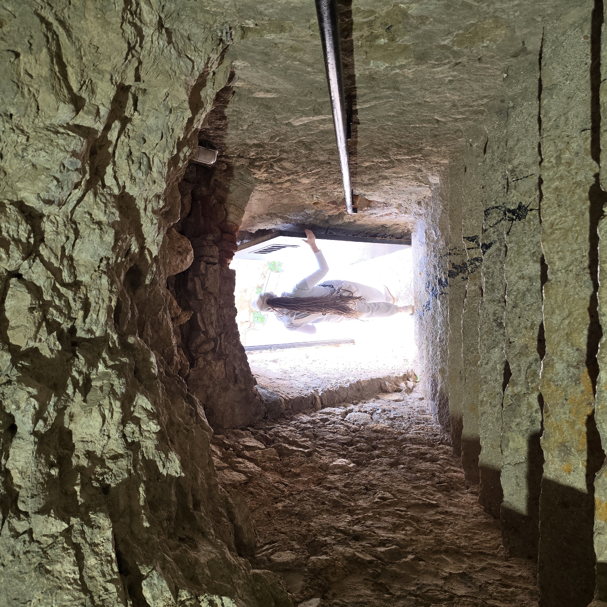 Stone tunnel complex with arched chambers documented by witness
