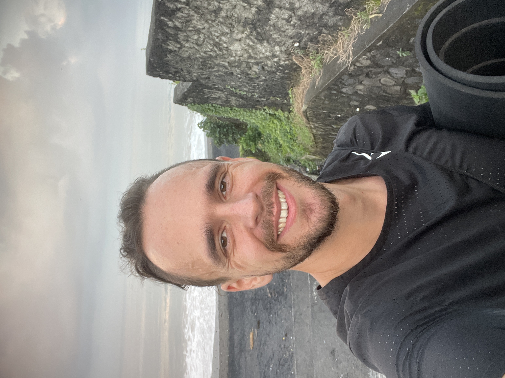 Moody black sand beach in Kediri under overcast skies