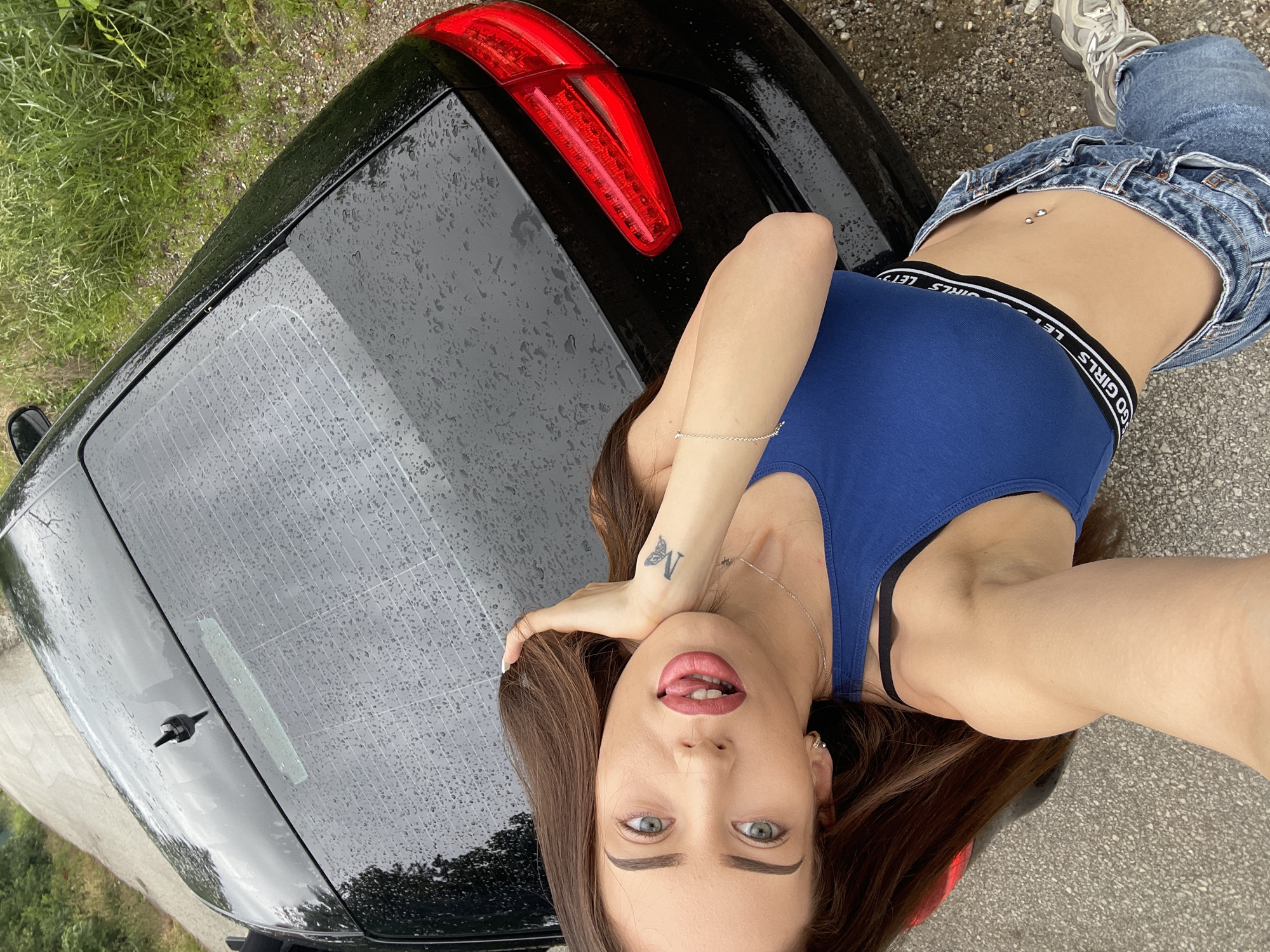 Woman poses with black Audi in impromptu roadside photo session