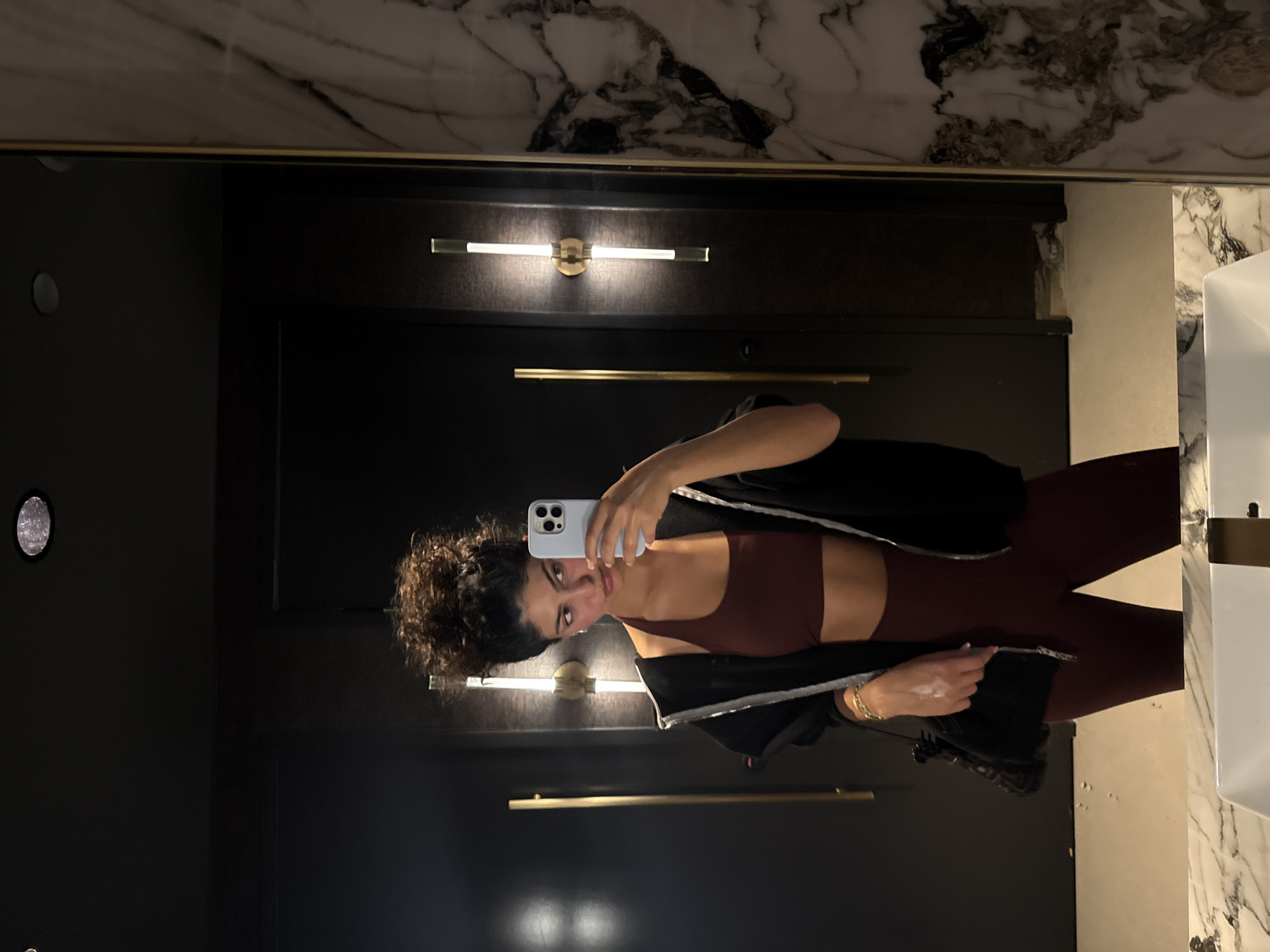 Woman takes selfie in West Hollywood commercial bathroom