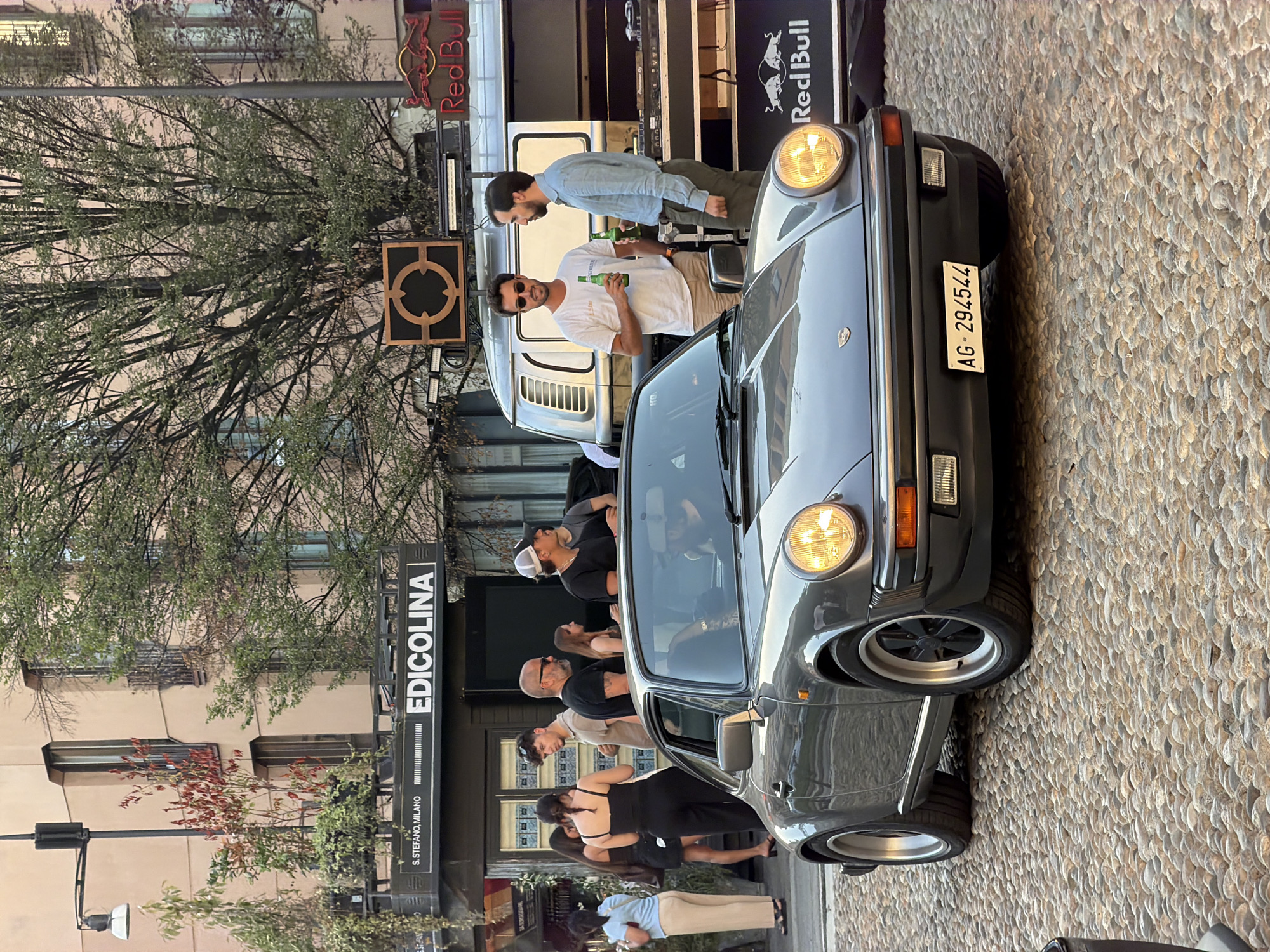 Classic car meetup on Milan cobblestones at golden hour