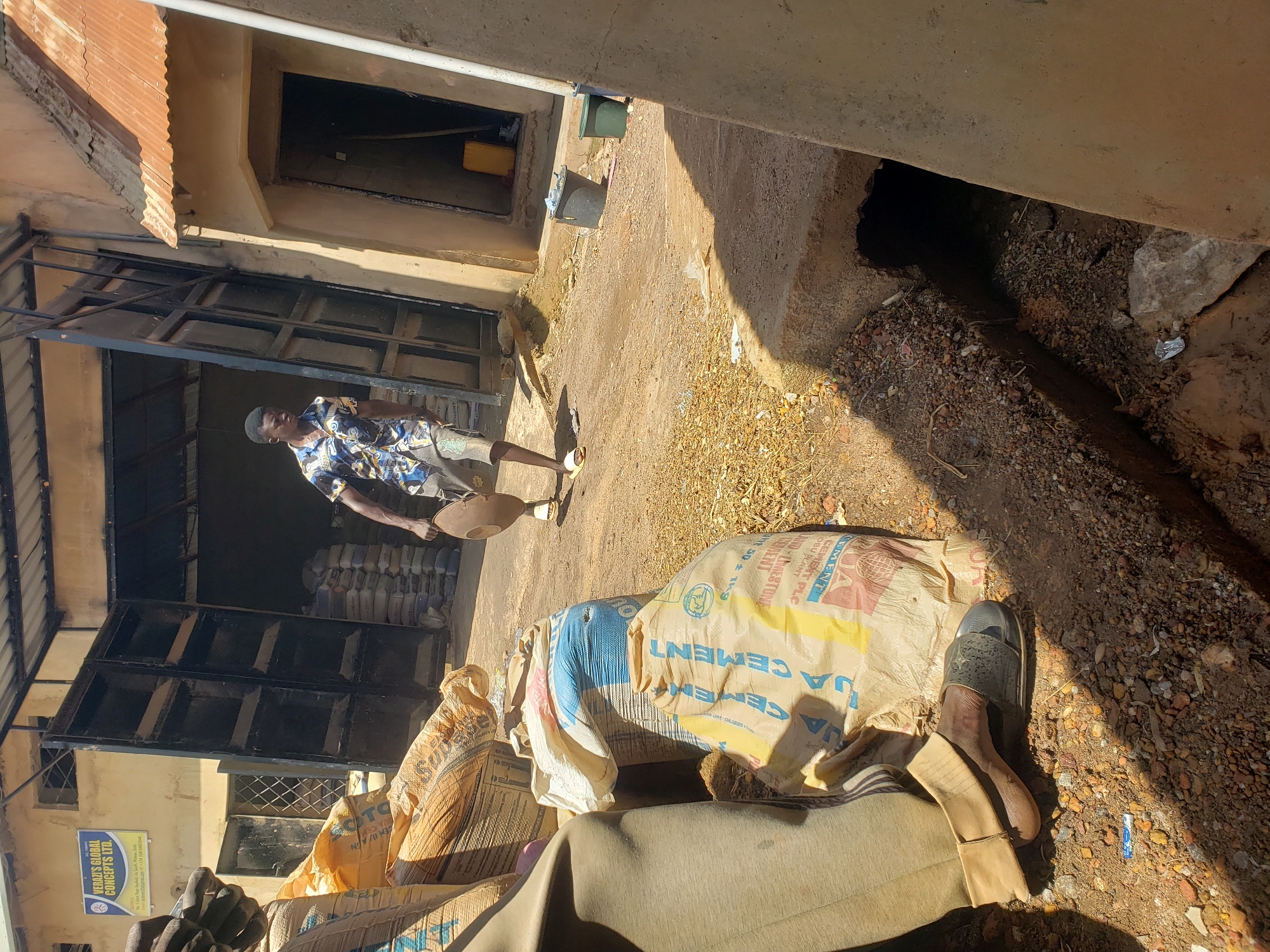 Workers handle cement bags at Jos warehouse during morning operations