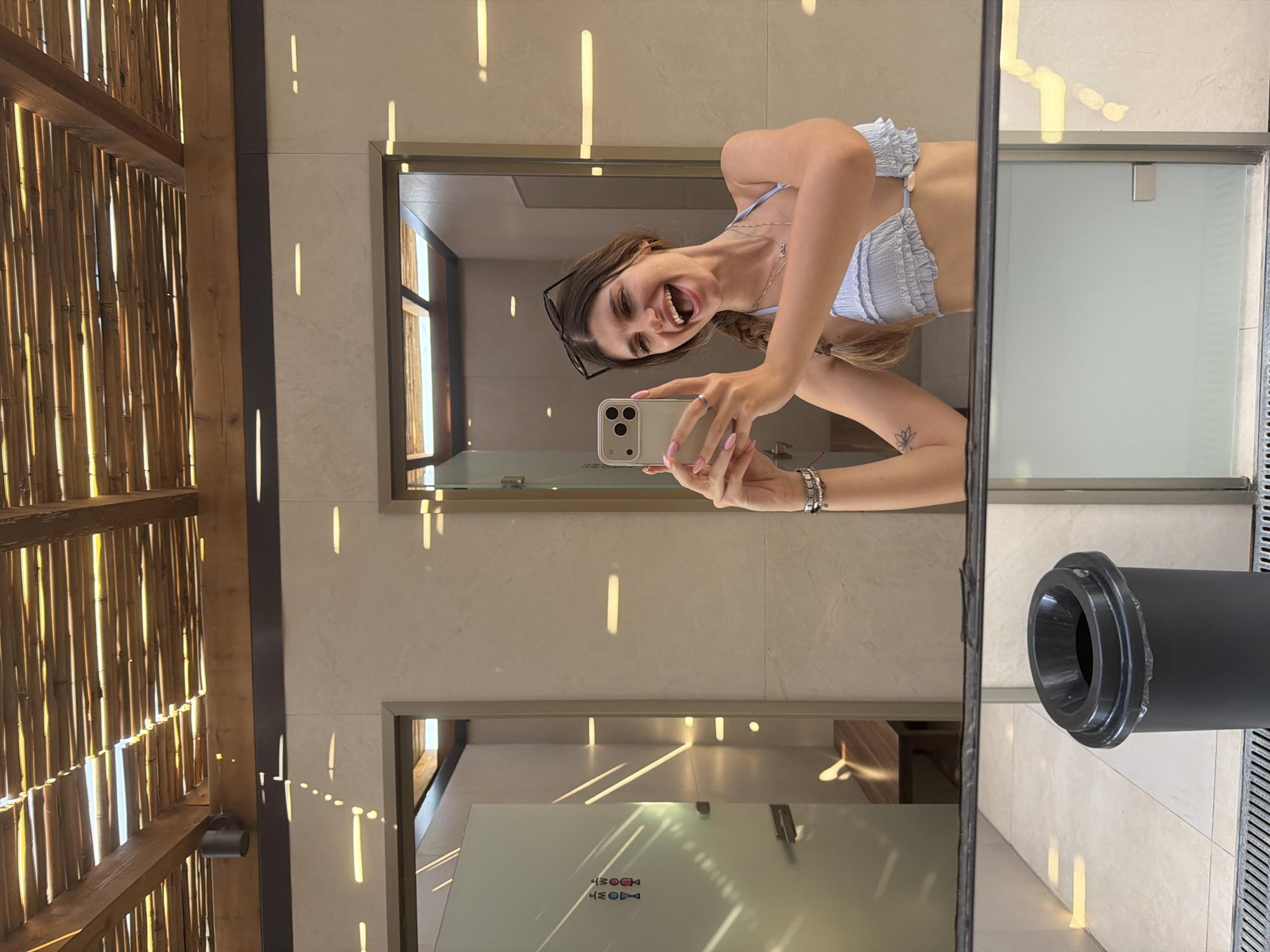 Woman documents beach day selfies at Greek resort