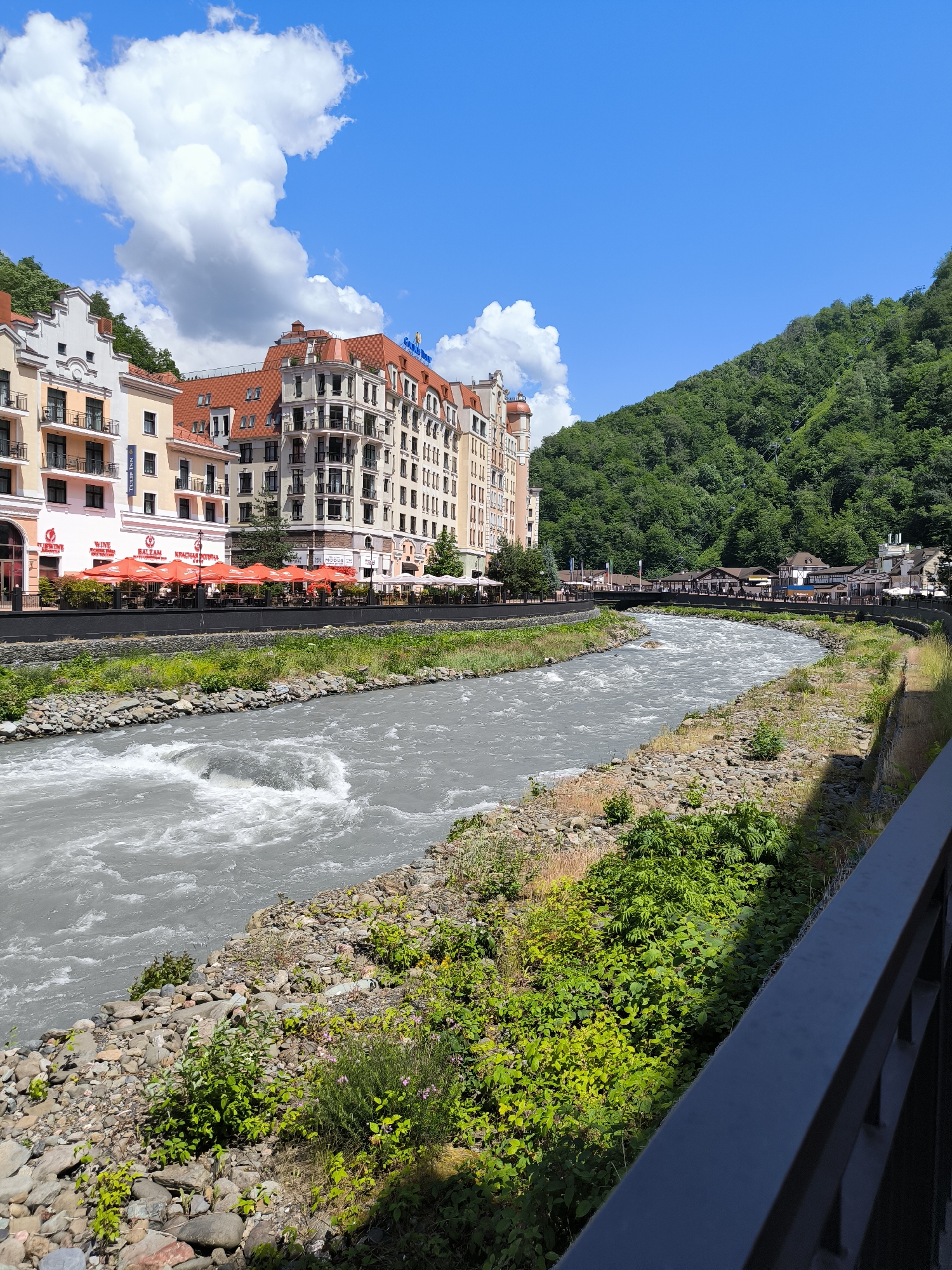Mzymta River rushes past Estosadok's mountain-backed embankment