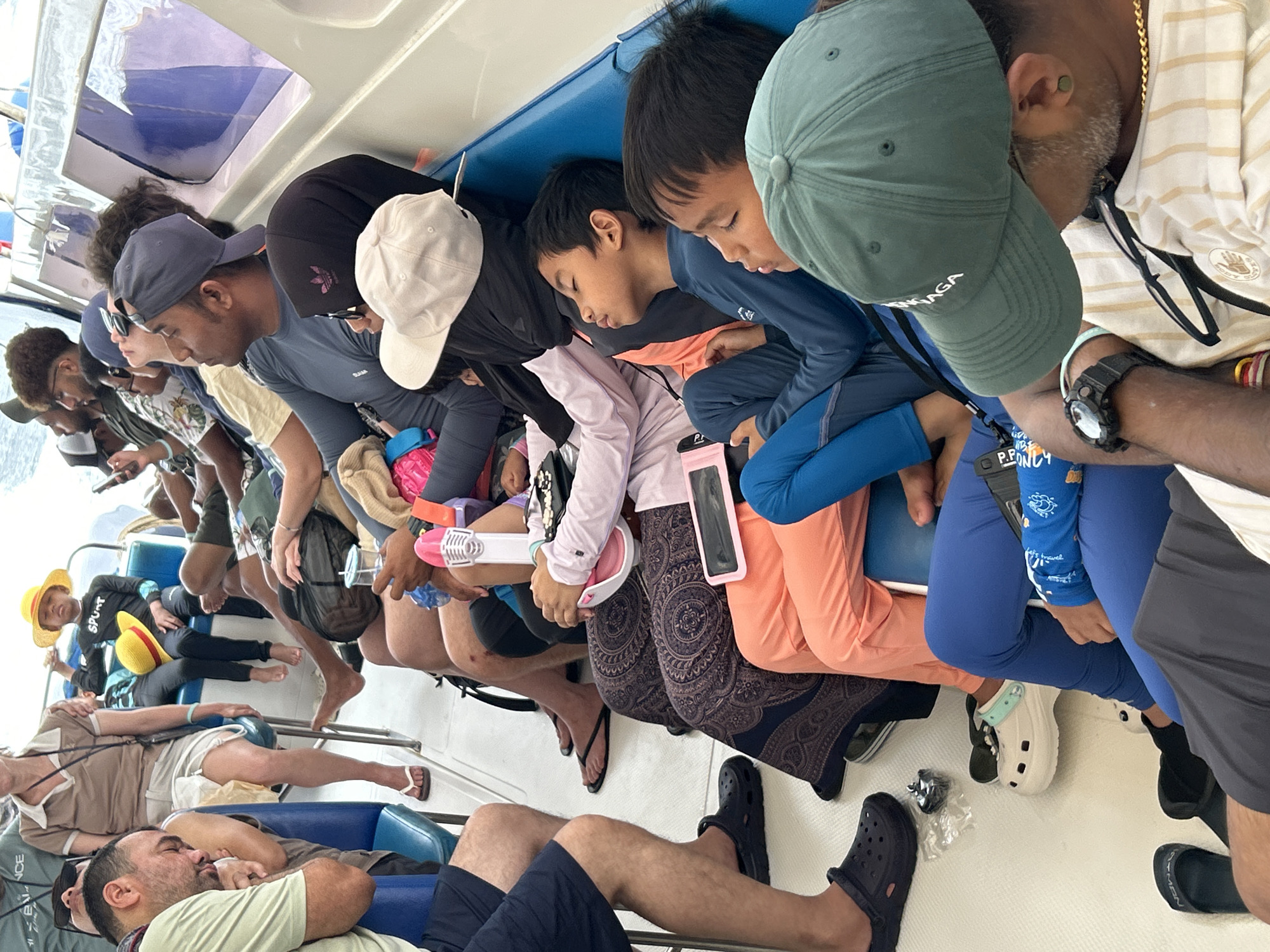Boat passengers rest during early morning journey near Rawai