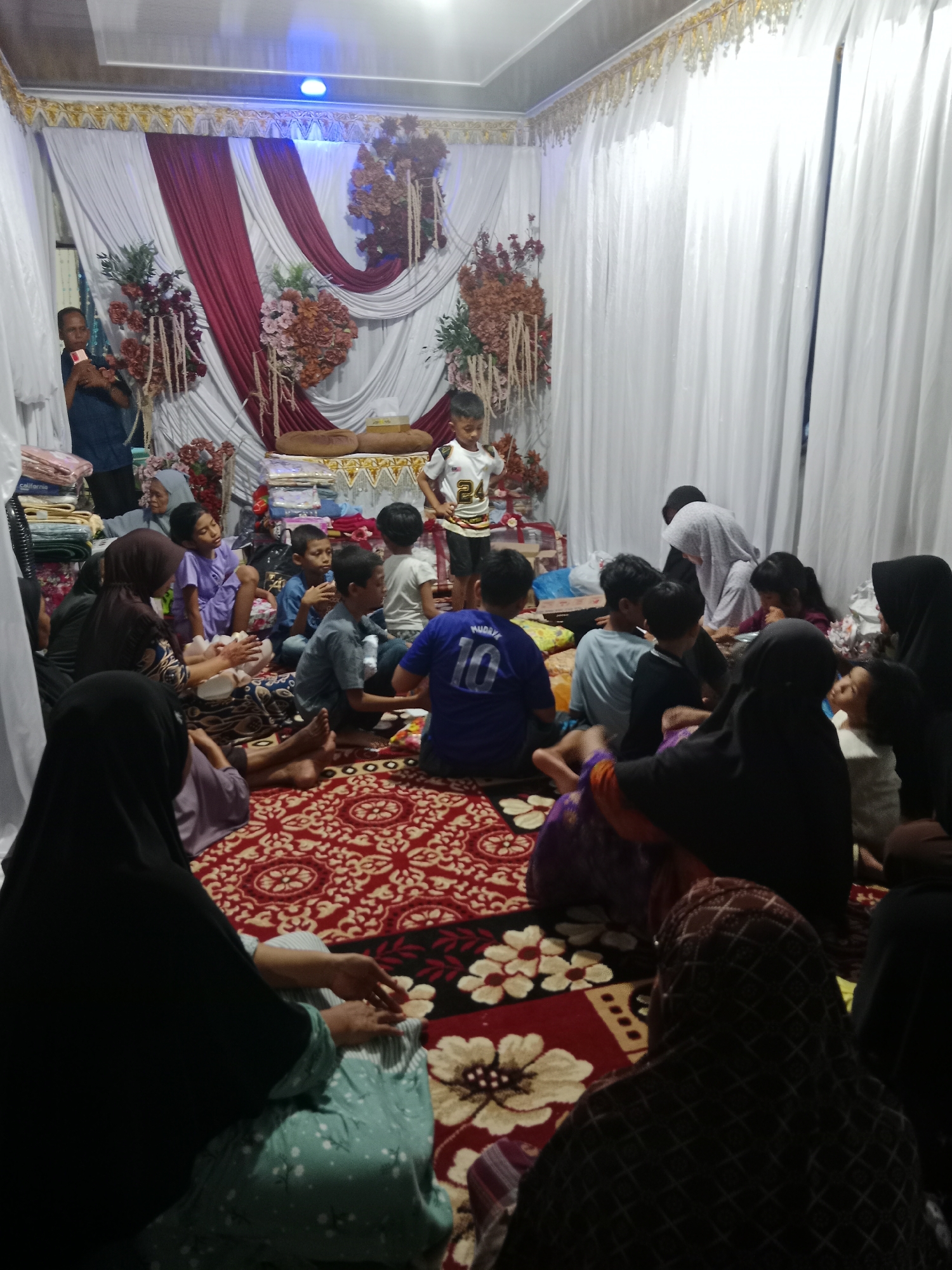 Indoor social gathering with families documented at mystery coordinates