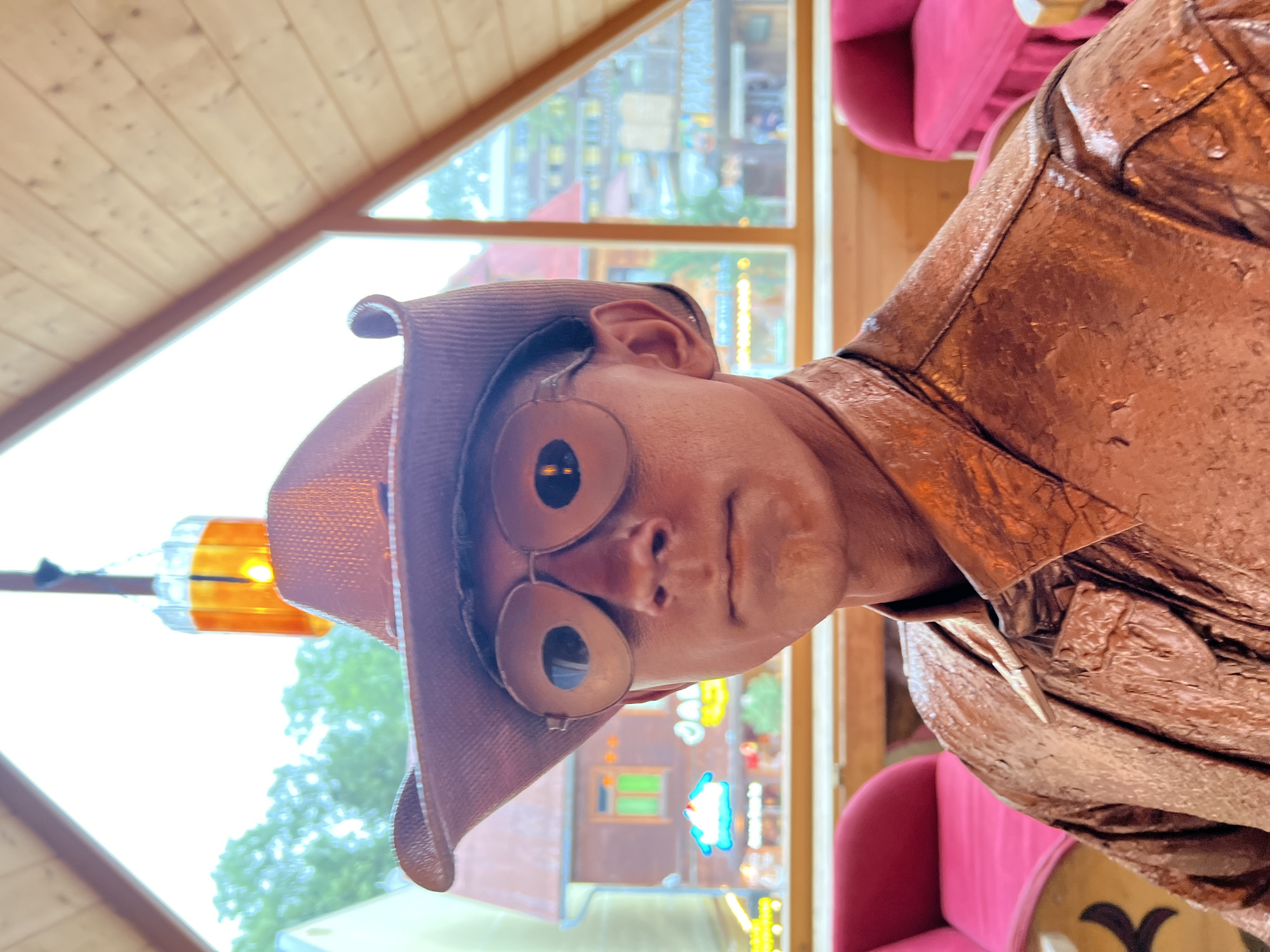 Copper-painted living statue inside Zakopane, cowboy hat and glasses