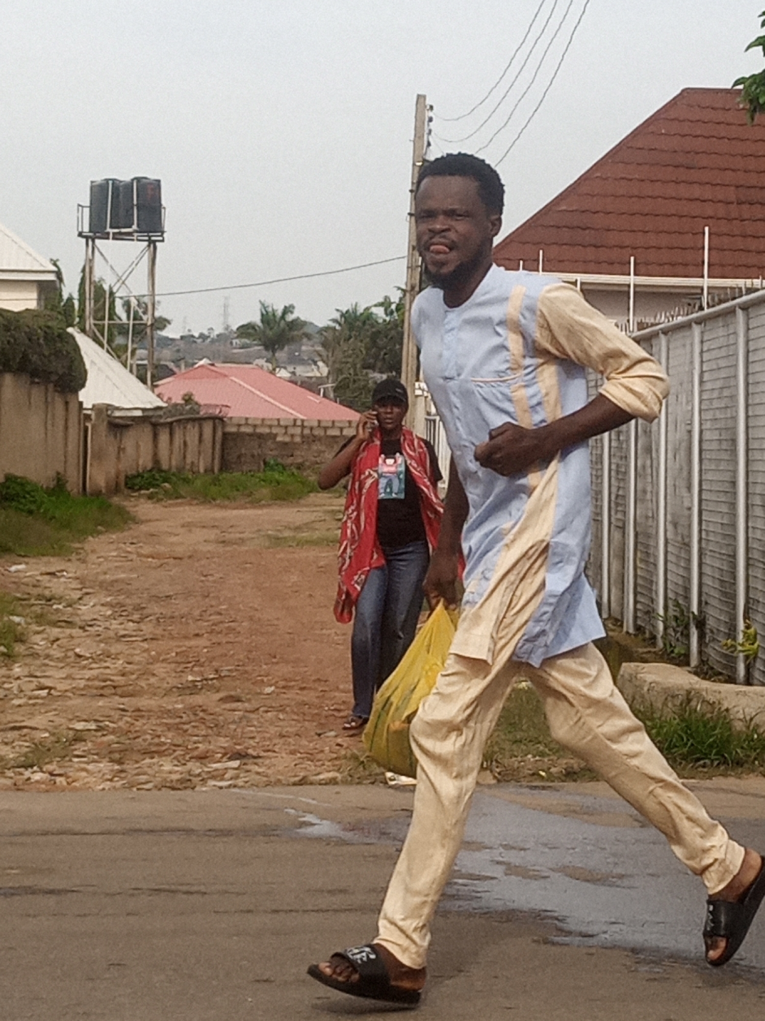 Everyday street life along dusty roads in a developing urban area