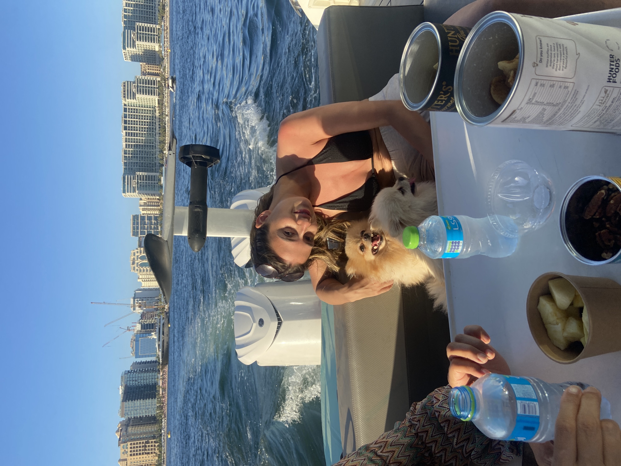 Woman with dog enjoys boat ride in Dubai waters