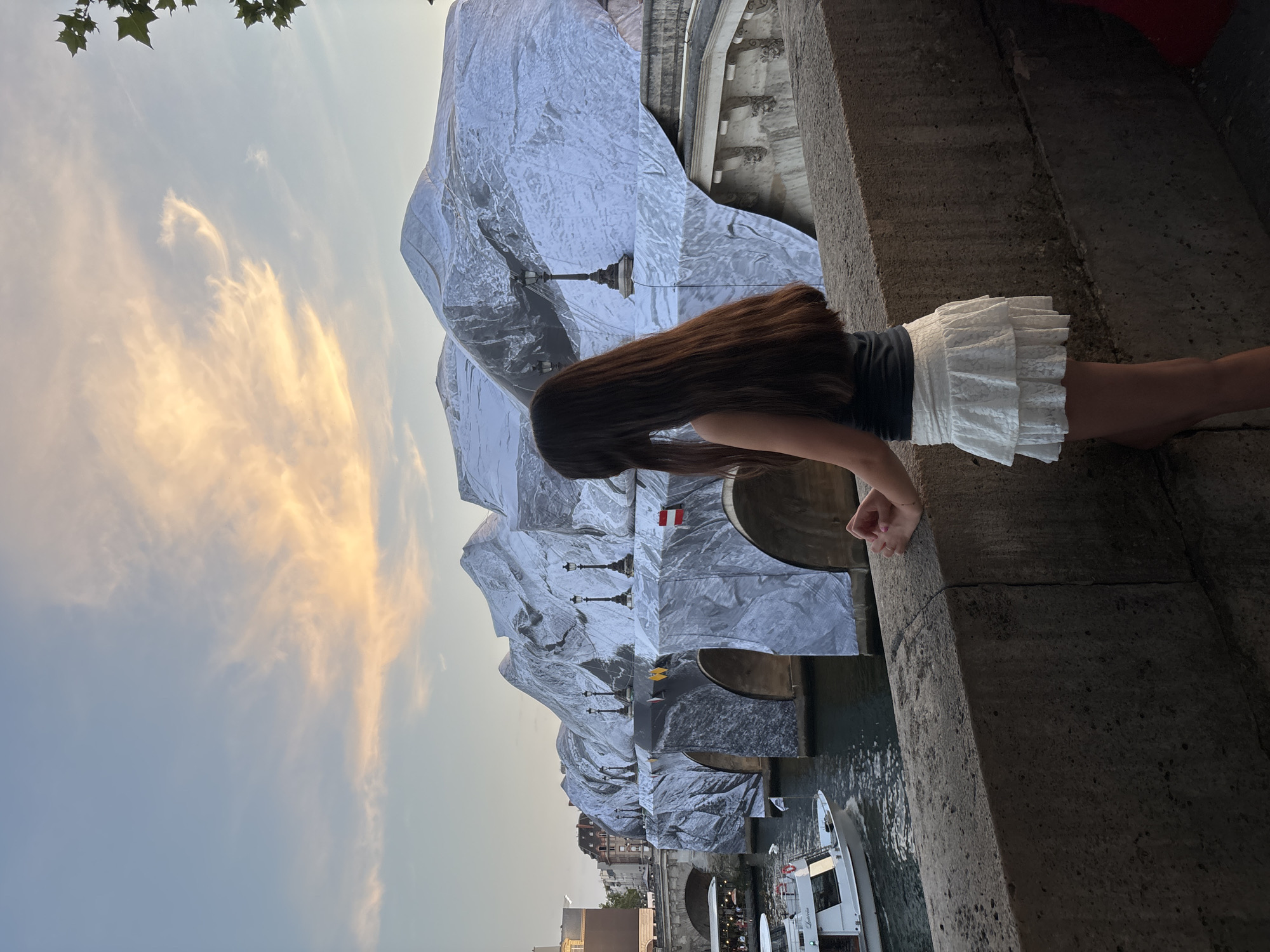 Seine-side Paris landmarks at golden hour, with a Pont Neuf installation