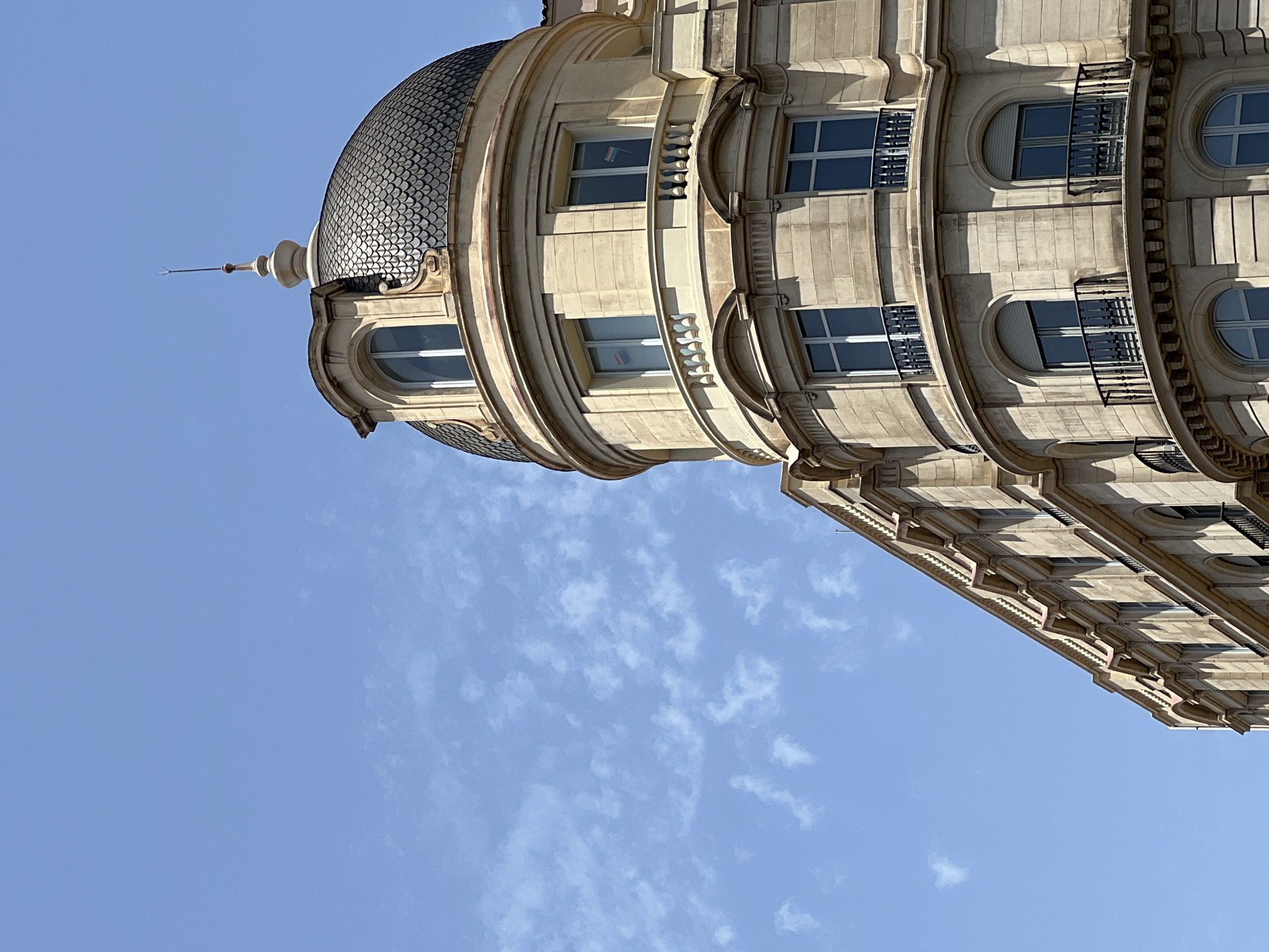 Ornate Barcelona building corner framed against a blue sky