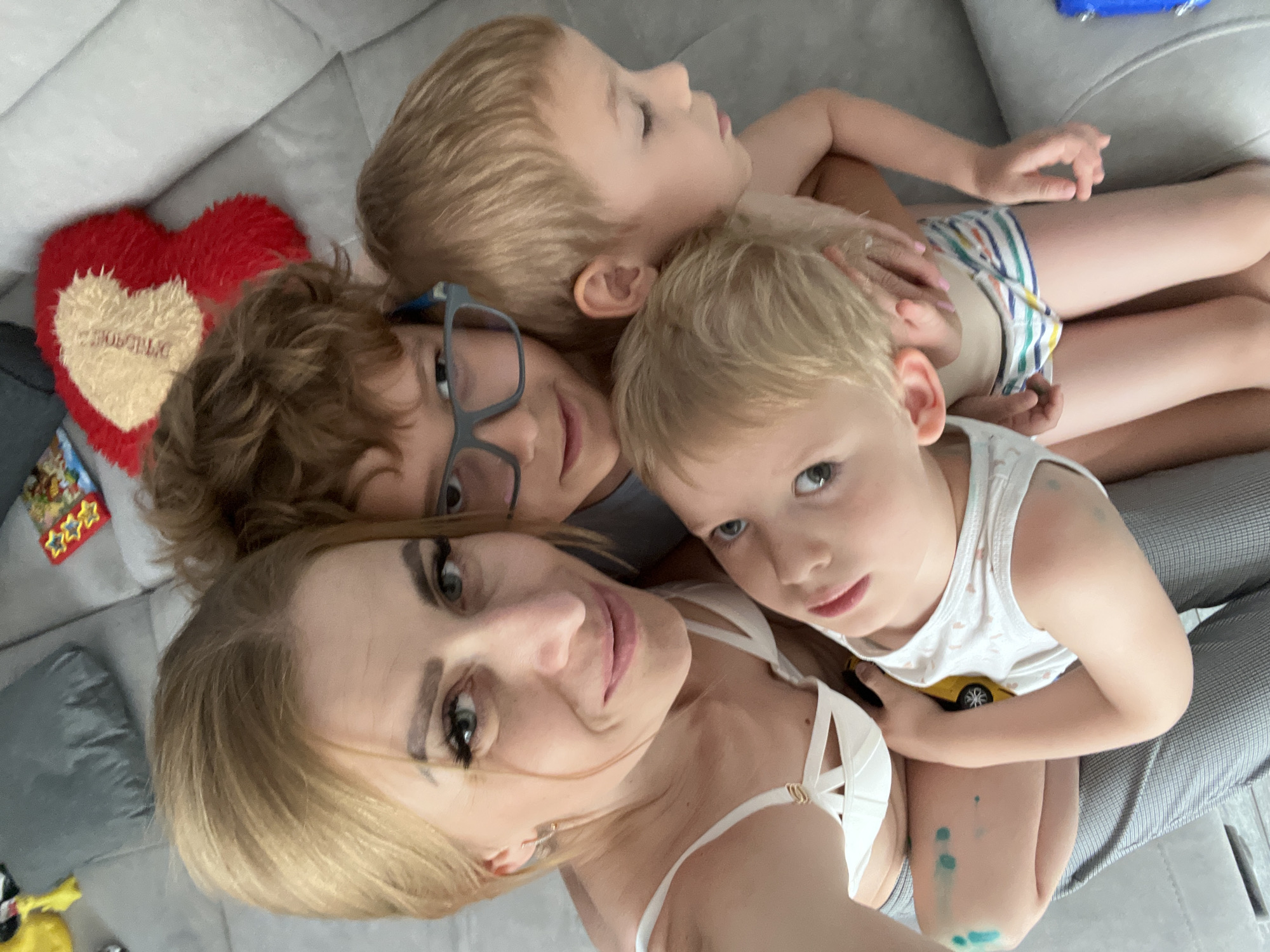 Indoor group selfie with family gathered close together