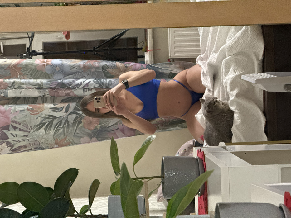 Woman documents bikini selfie session with cat in Petersburg