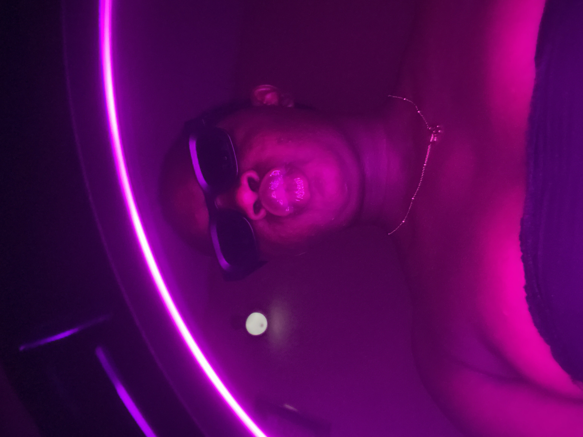 Person in illuminated tub under purple lighting in Nigeria