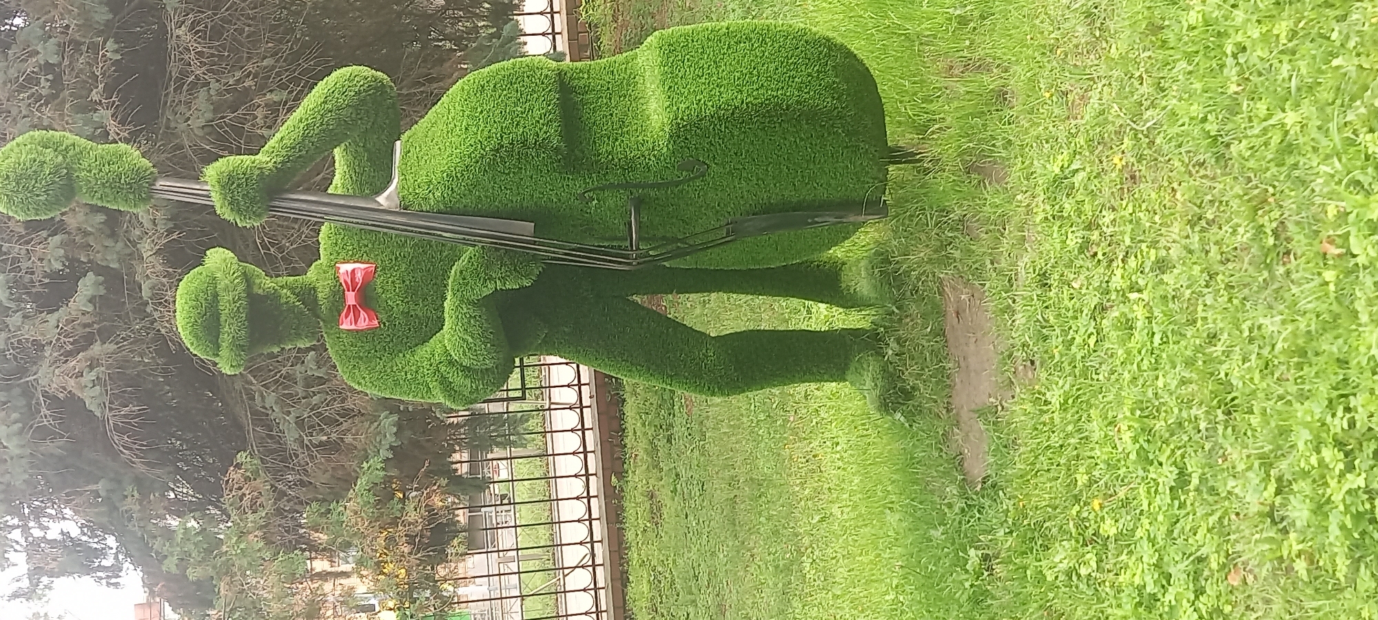 Topiary garden features musician and peacock shrub sculptures