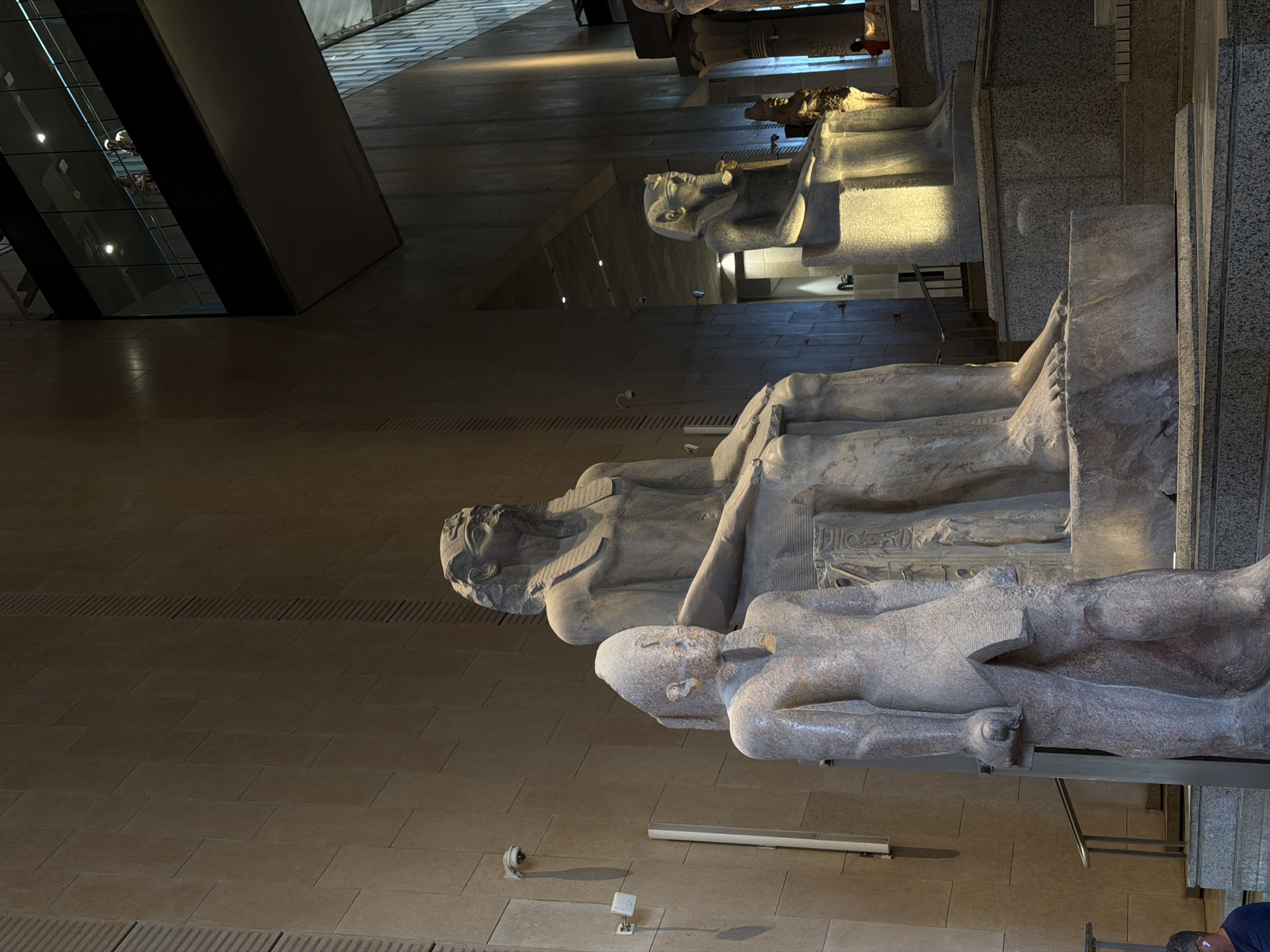 Inside the Grand Egyptian Museum with pharaohs and ancient stone