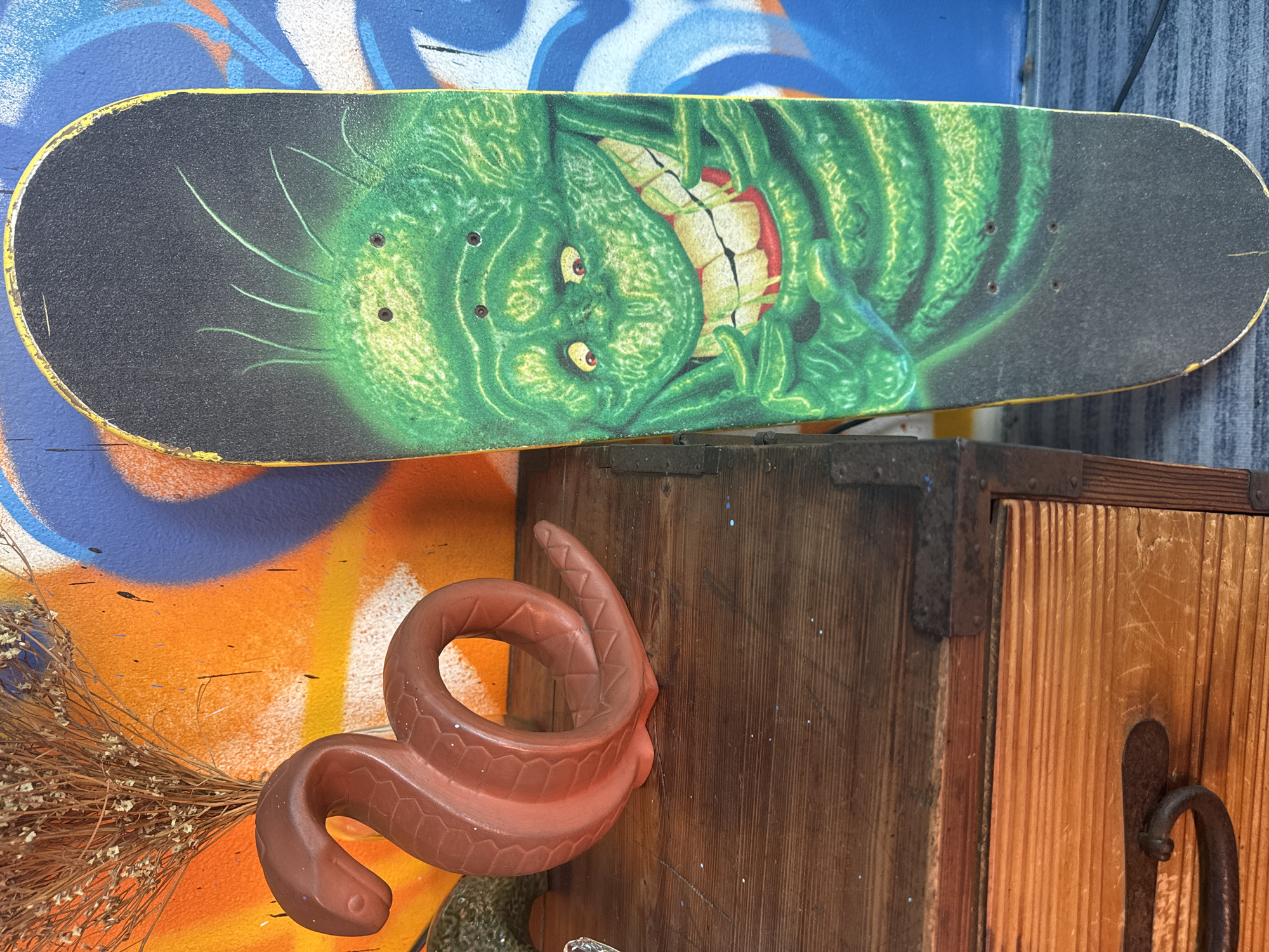 Skateboard and patterned furniture details in a casual interior setting
