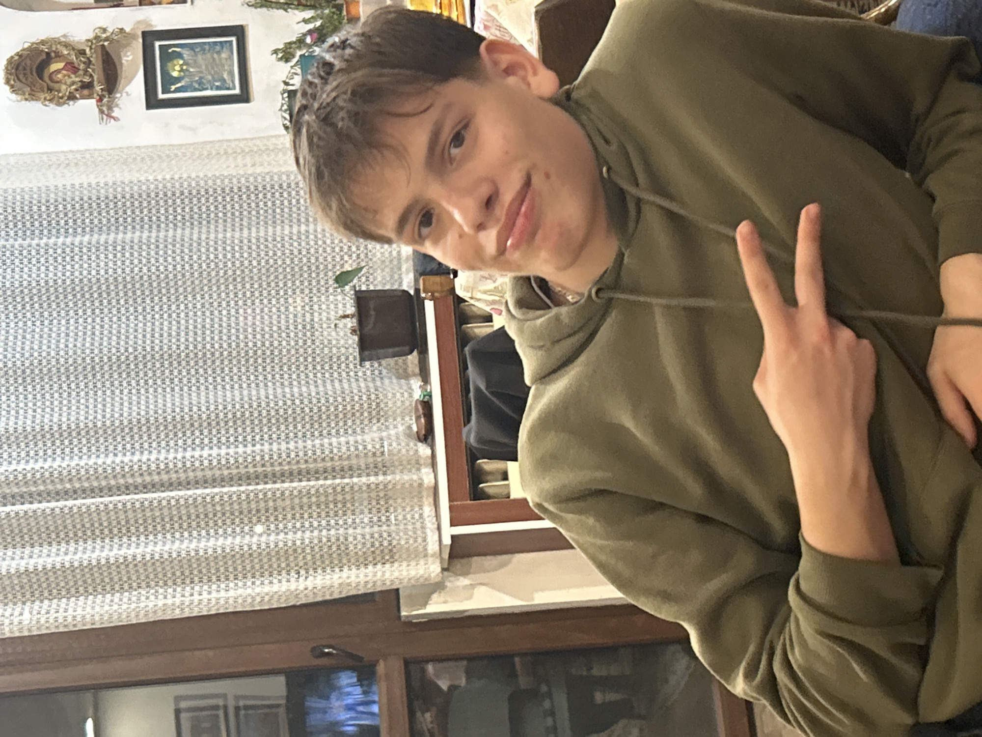Young man photographed twice indoors in Panagyurishte, Bulgaria
