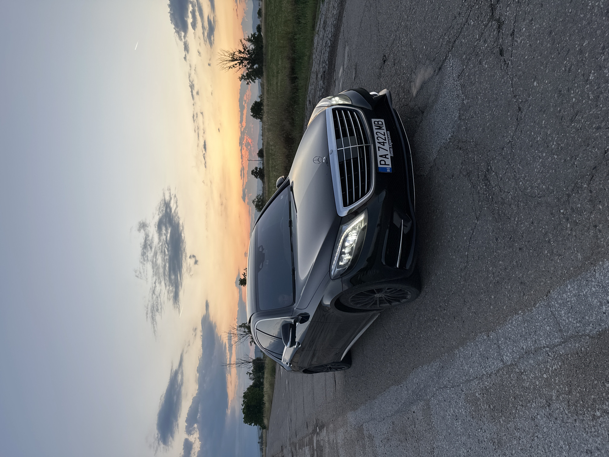 Black Mercedes S-Class spotted parked on cracked road at sunset