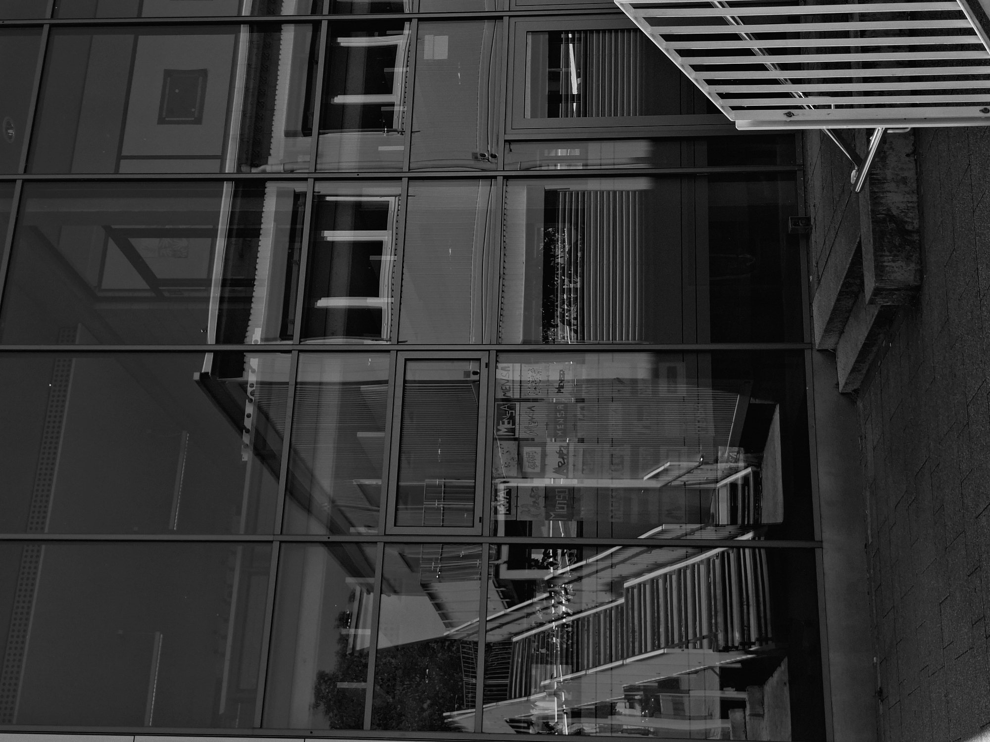 Glass building exterior and a car interior, same morning.