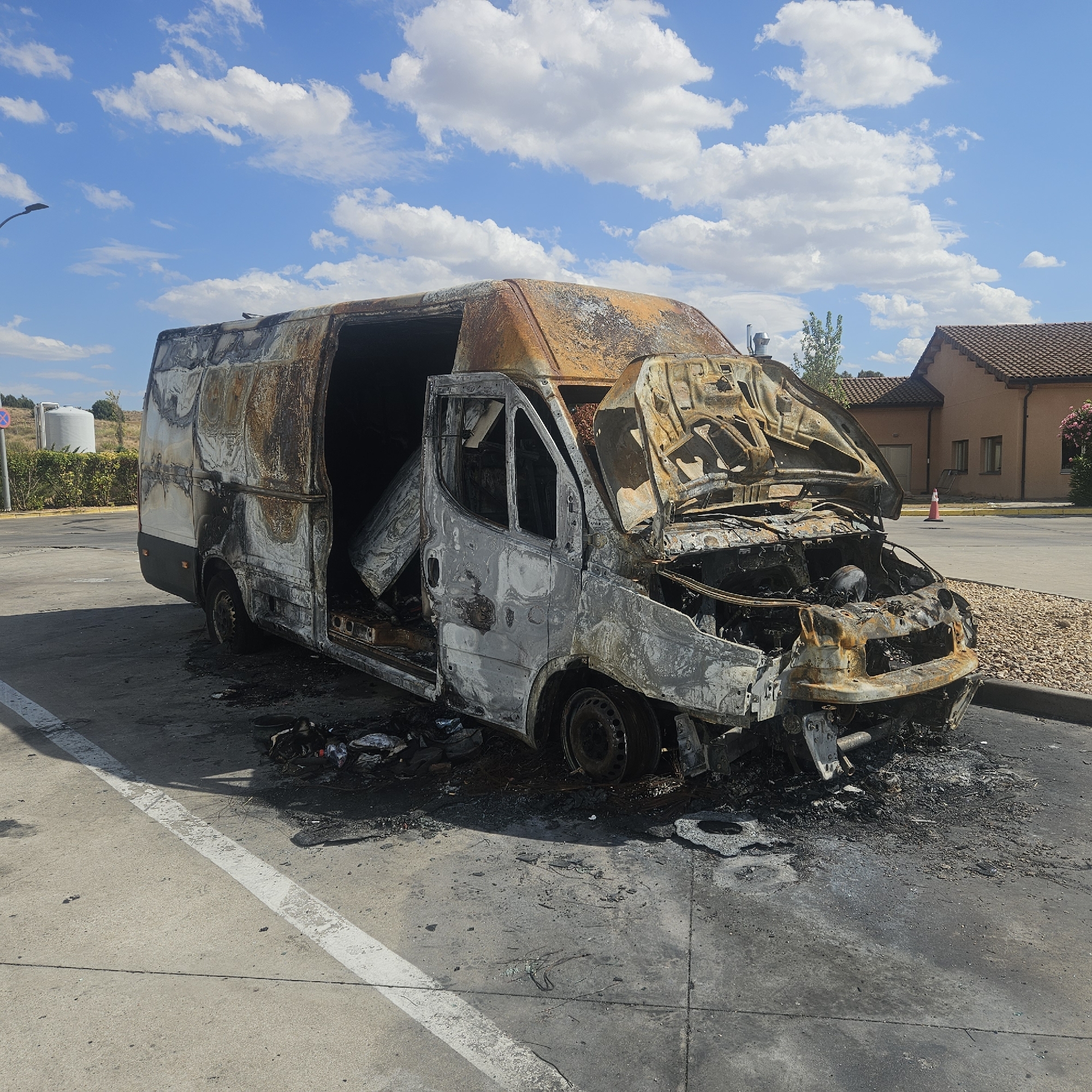Burned-out van on the roadside in rural Castile