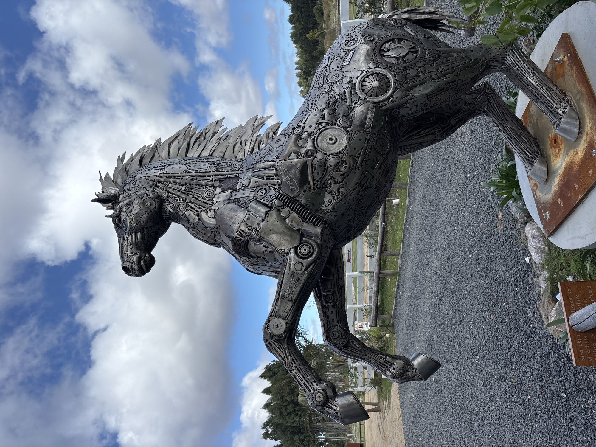 Outdoor sculptures and vintage machinery documented in Marindia, Uruguay