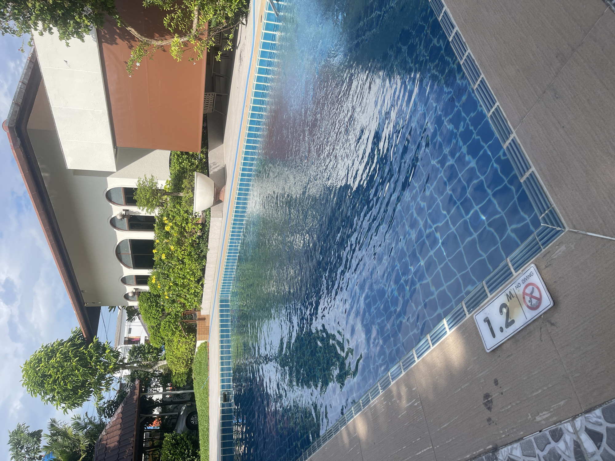 Poolside property in Ratsada with motorcycle and garden flowers