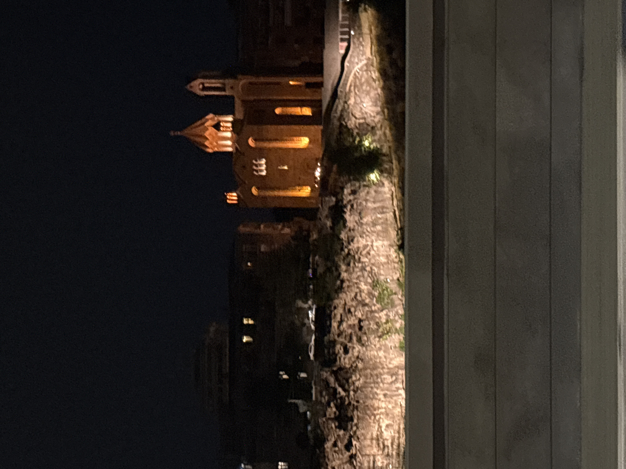 Nighttime drive through Yerevan, passing a lit cathedral