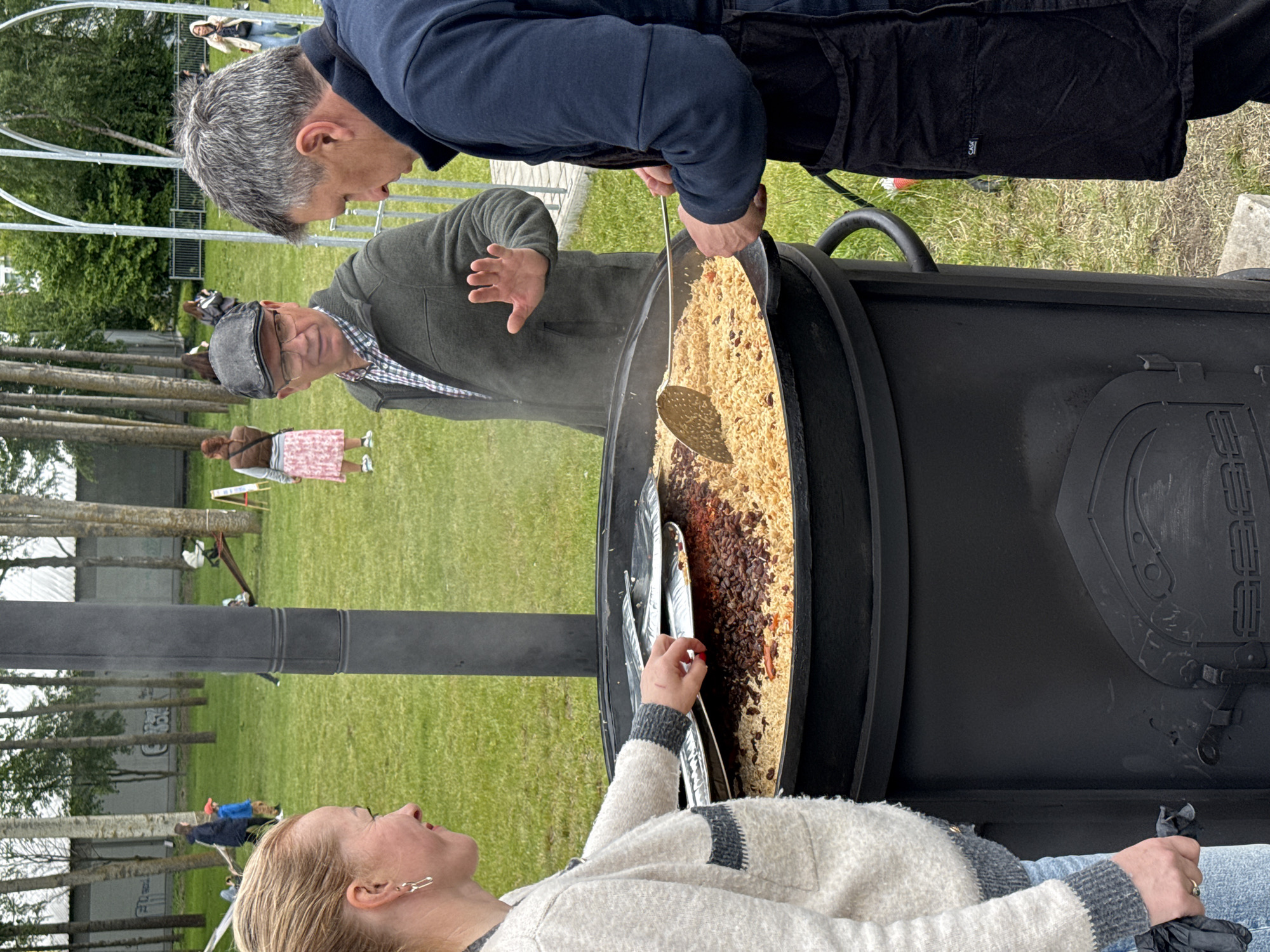 Outdoor pilaf cooking event documented in Riga park setting